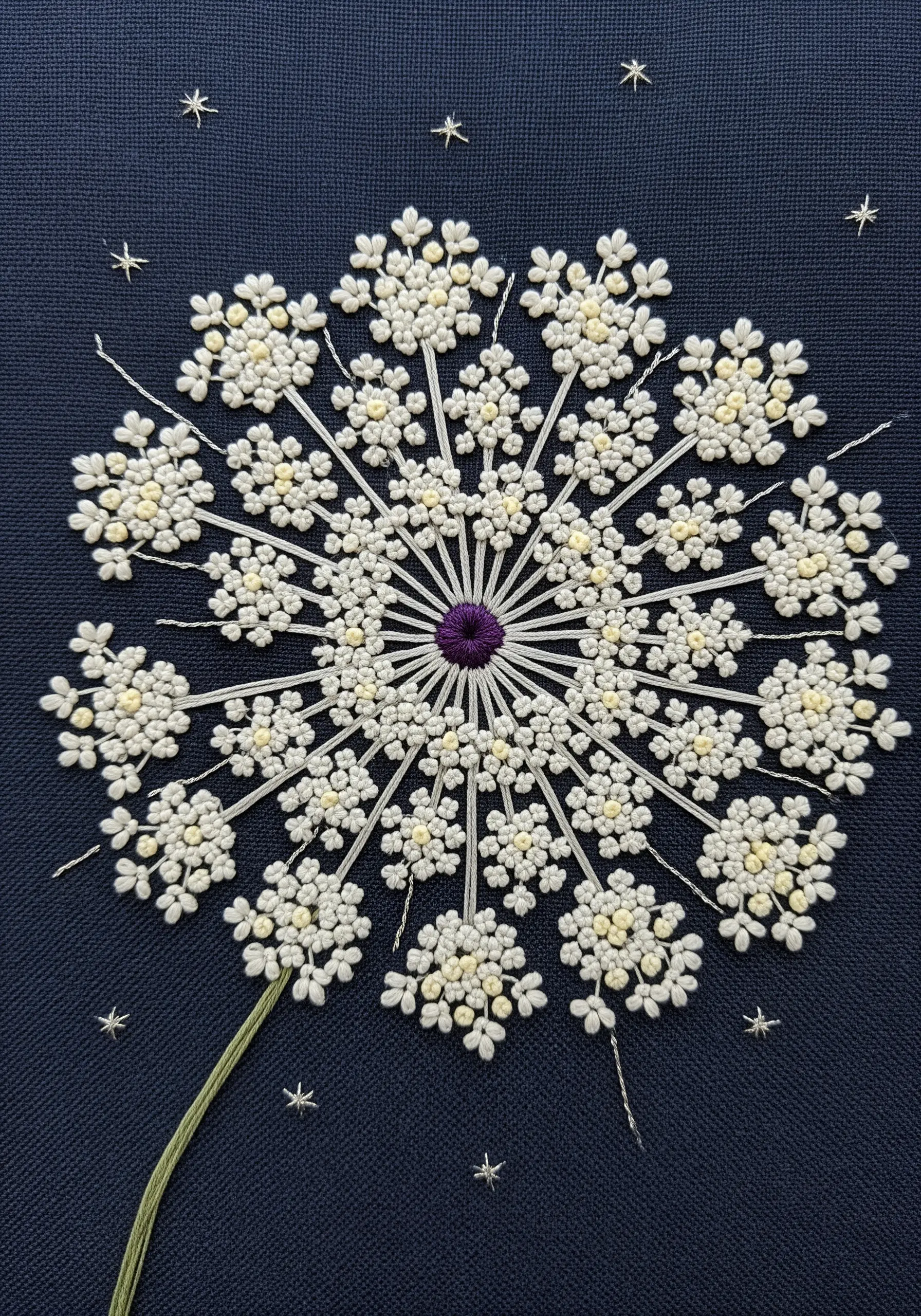 A close-up of an embroidered Queen Anne's Lace flower made of tiny white and yellow French knots.