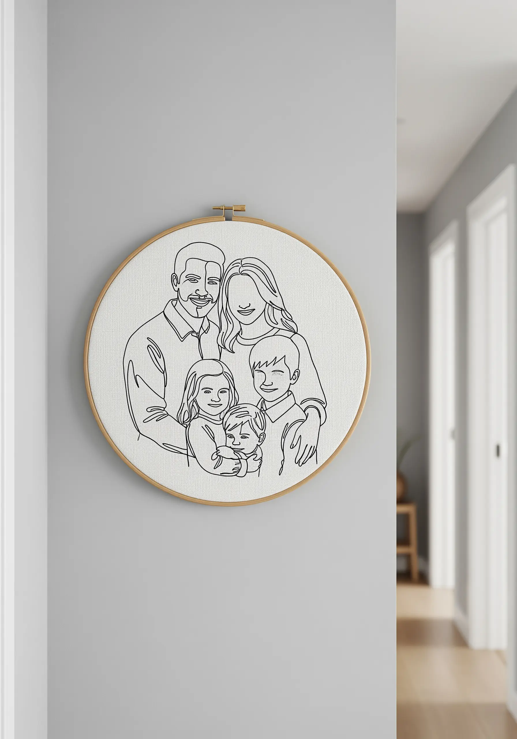 A family portrait rendered in a single, continuous black line on white fabric in a hoop.