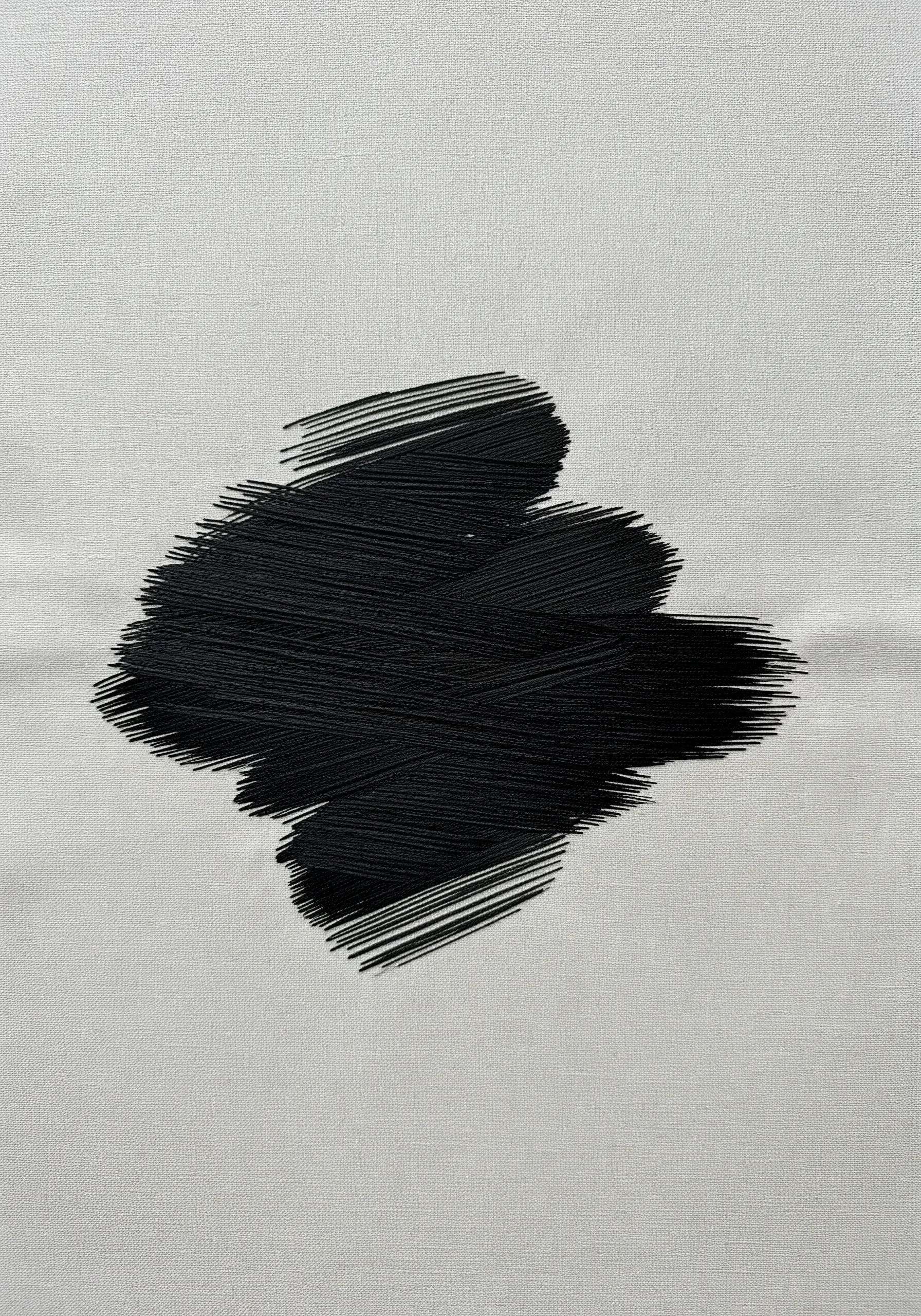 A dense, black, abstract brushstroke embroidered with layered straight stitches on linen.