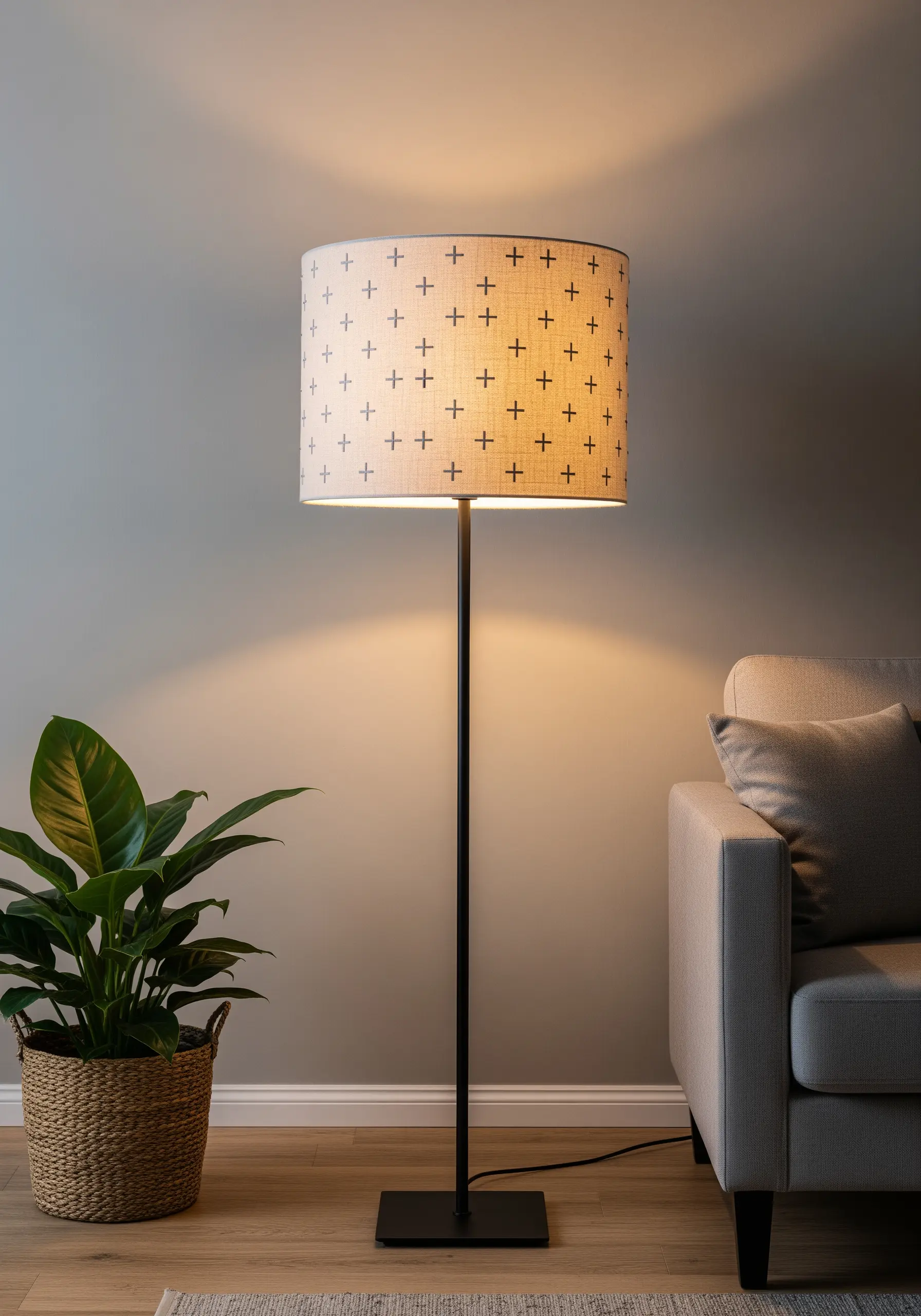 Fabric lampshade with a repeating pattern of small embroidered black crosses.