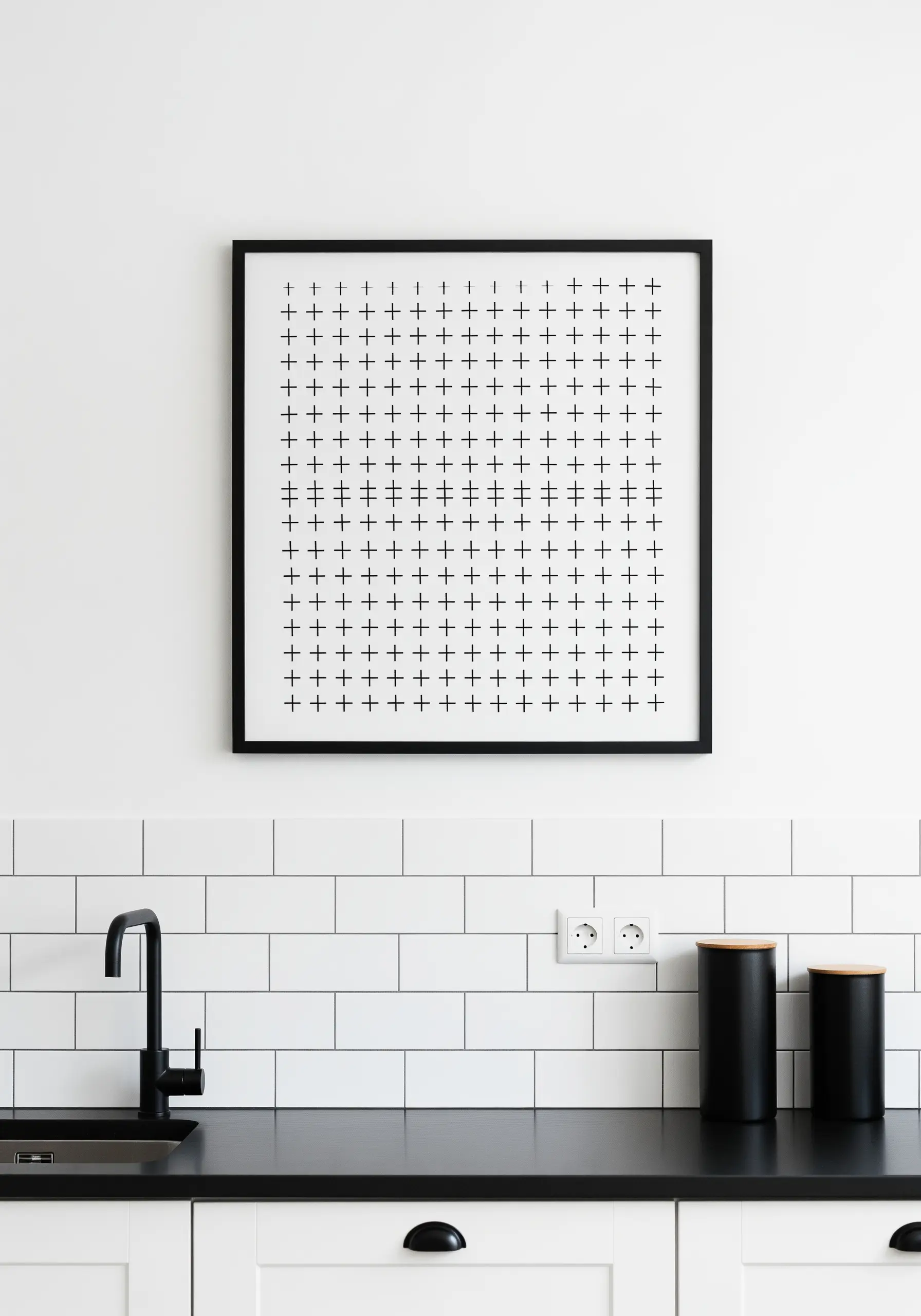 A framed piece of embroidery featuring a precise grid of black plus-sign stitches.
