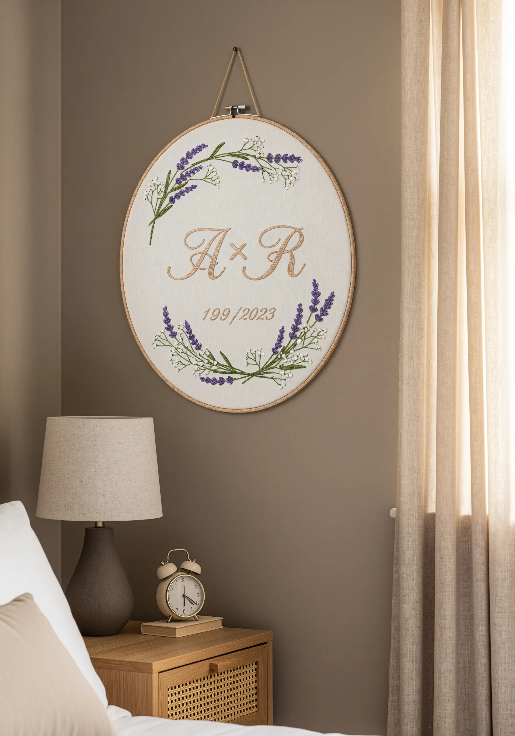 An embroidery hoop with initials, a date, and a wreath of lavender and baby's breath.