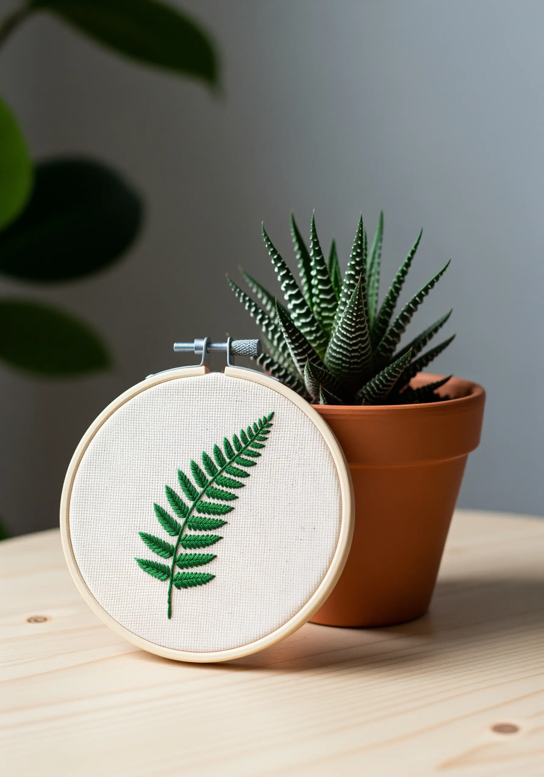 A vibrant green fern leaf embroidered using the symmetrical fishbone stitch.