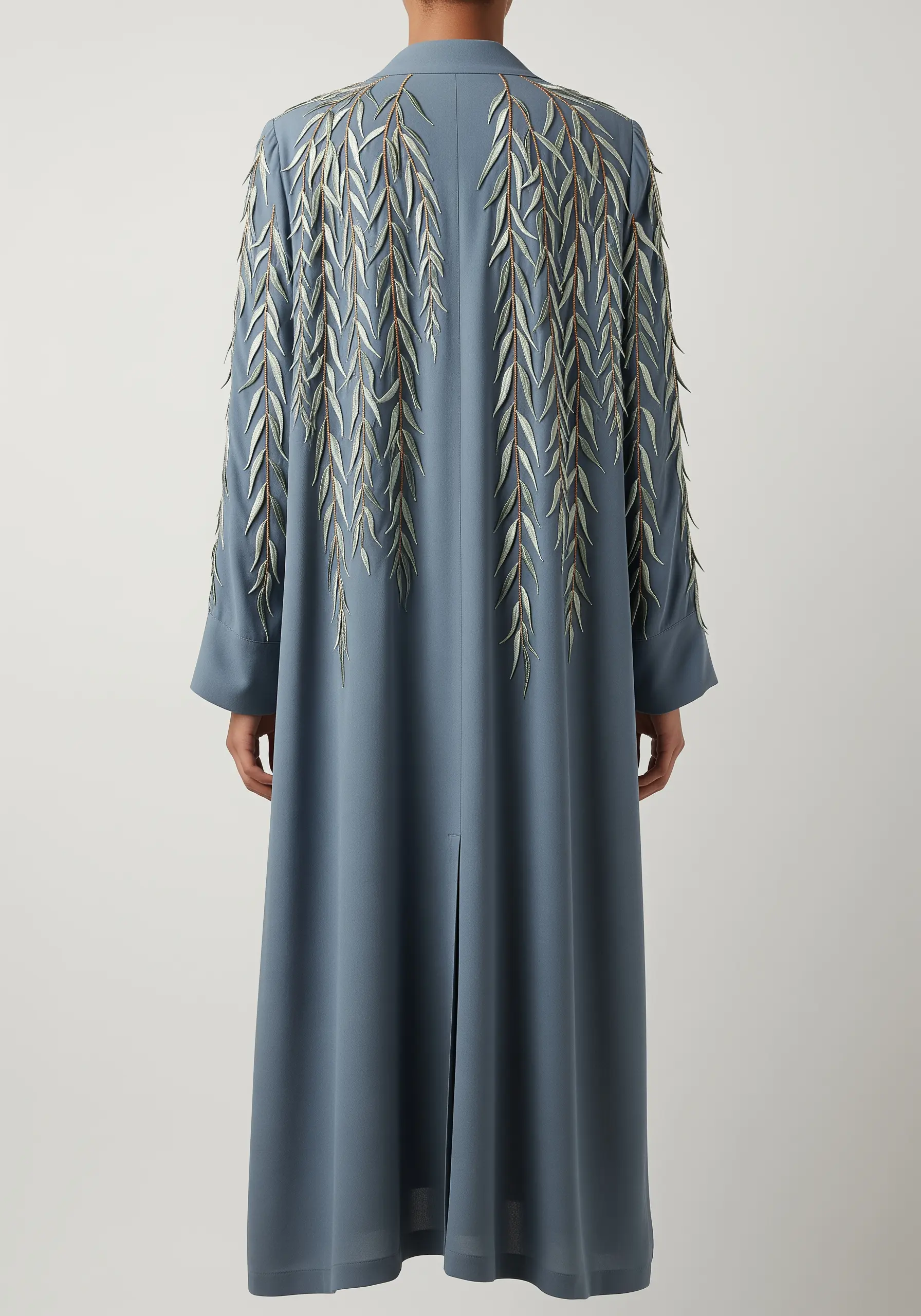 A cascade of 3D weeping willow leaves embroidered on the back of a long coat.