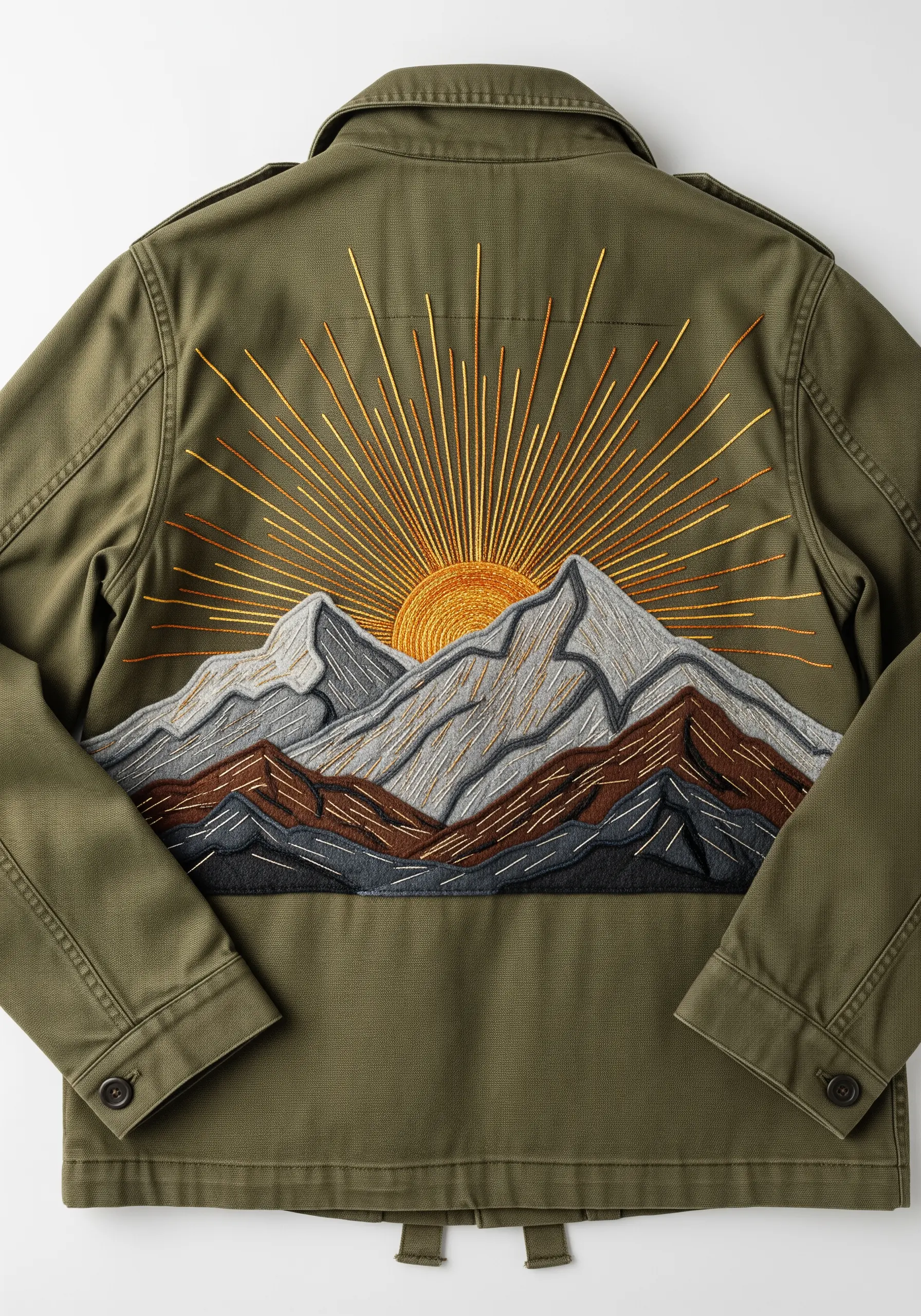 Mountain landscape embroidery with a radiant sunburst on an olive green jacket.