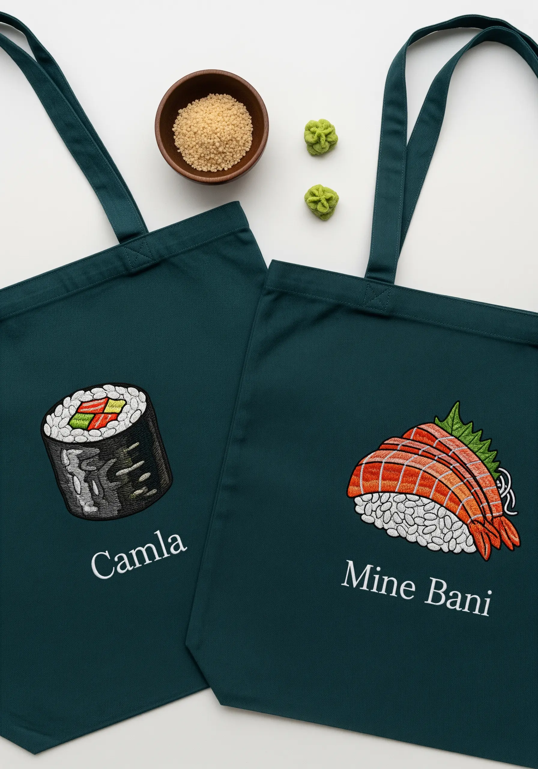 Dark green tote bags with personalized names and embroidered sushi rolls and nigiri.