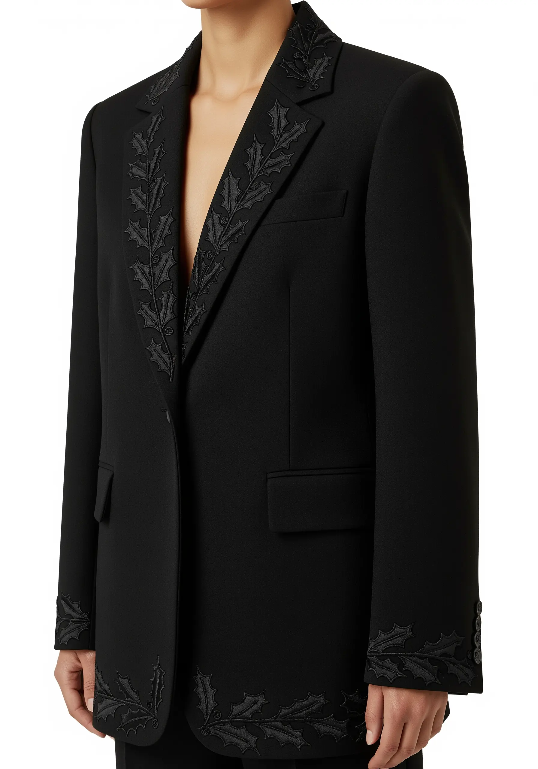 Tone-on-tone black holly leaf embroidery on the lapels of a black blazer.