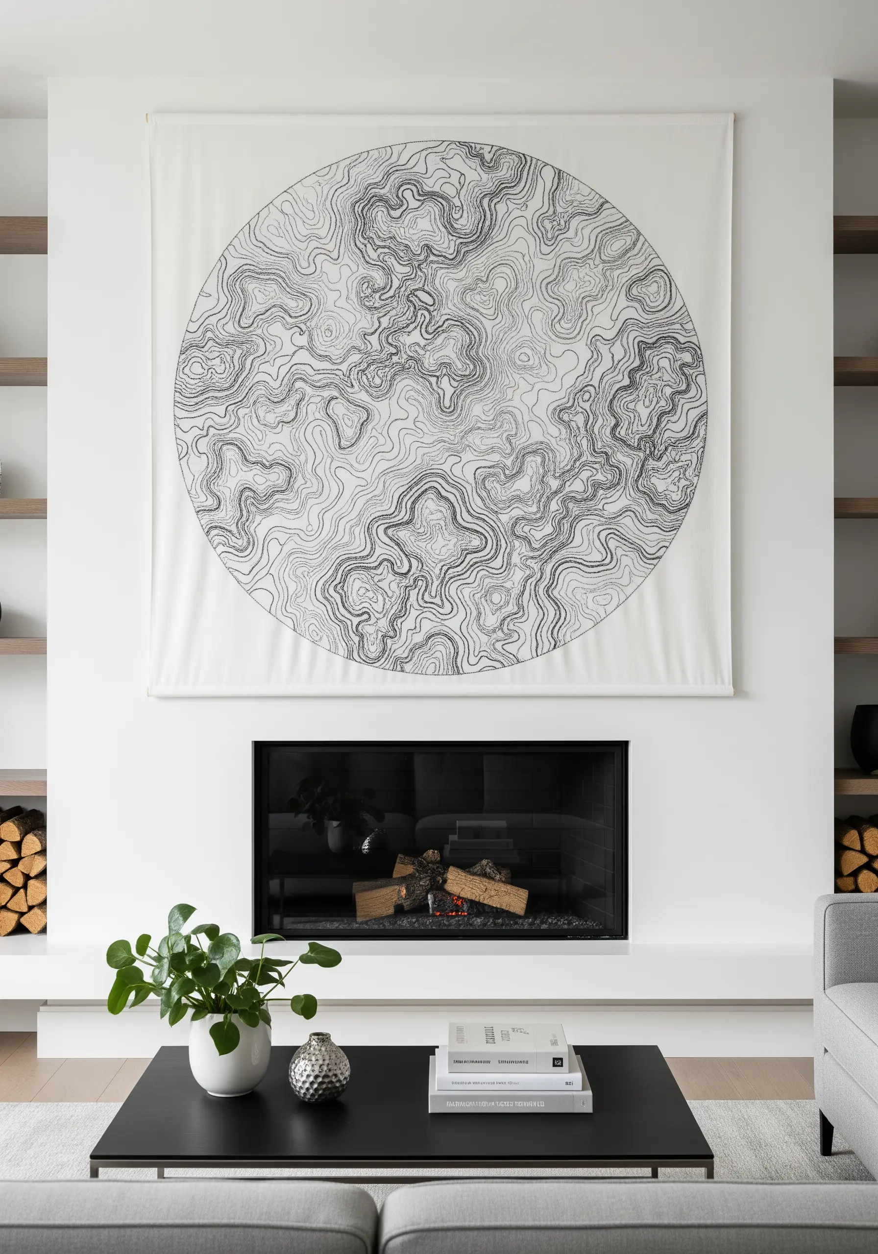 A large circular topographic map design embroidered in black thread on white fabric.