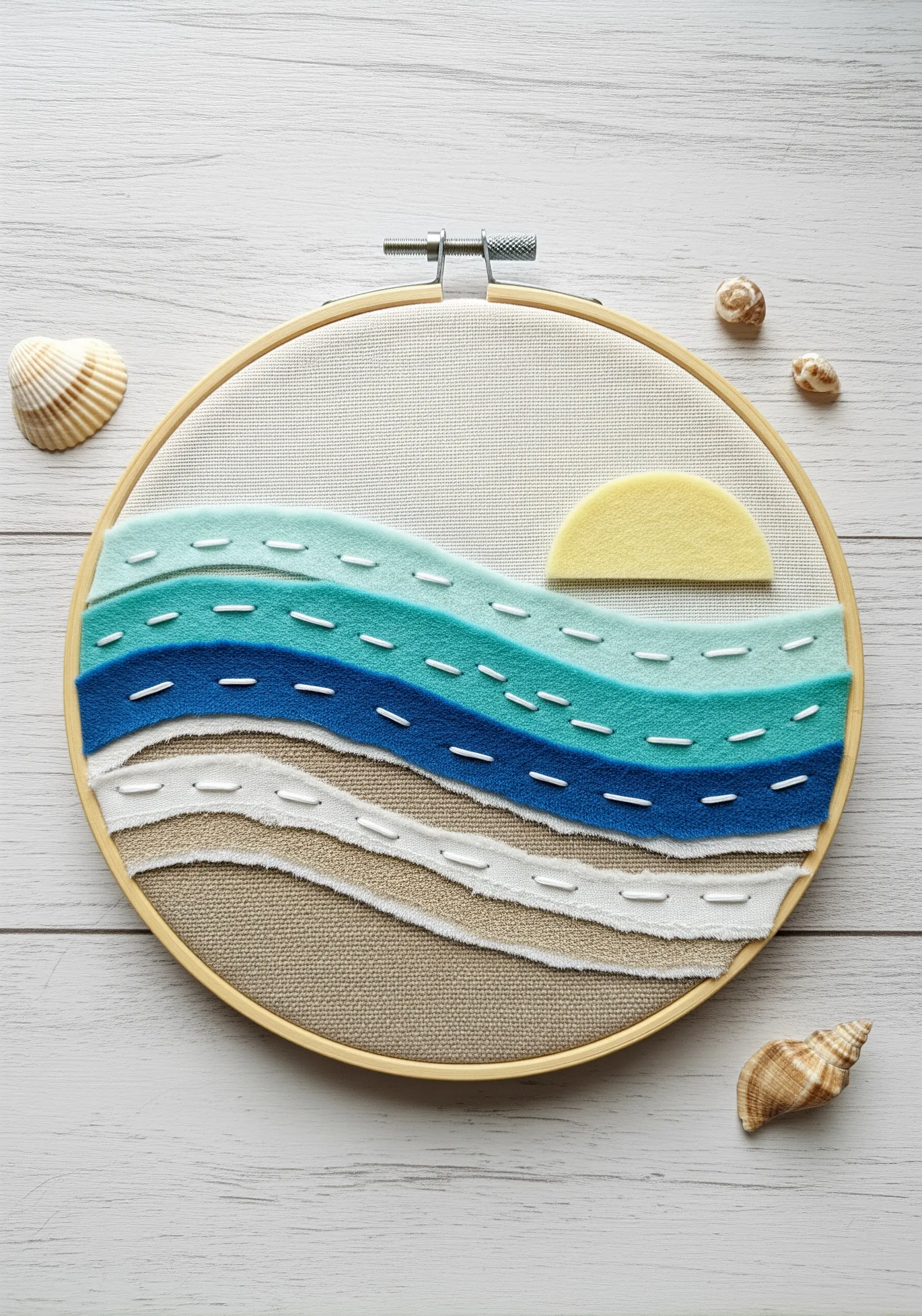 Layered fabric collage of an ocean scene with torn fabric edges.