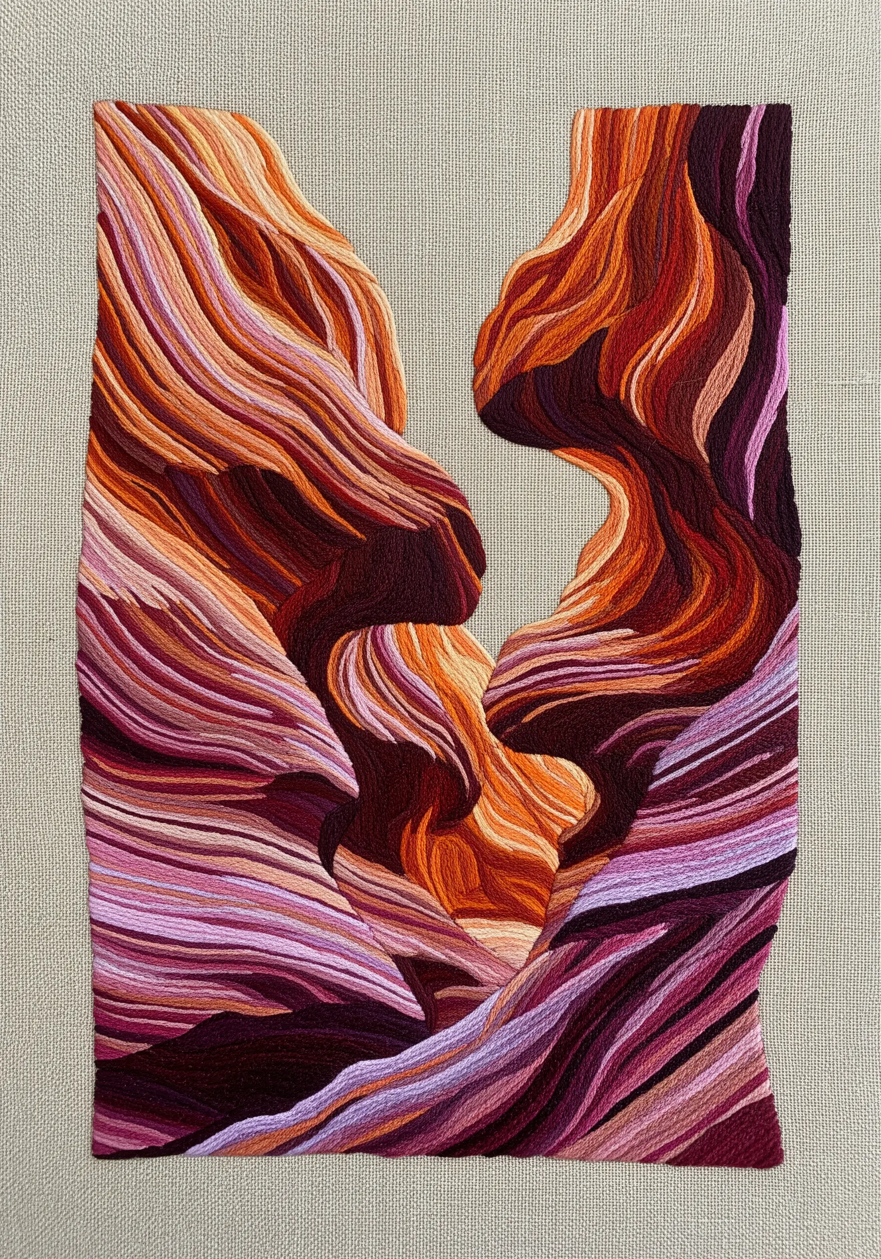 Abstract embroidery of slot canyon walls with flowing contour lines in warm tones.