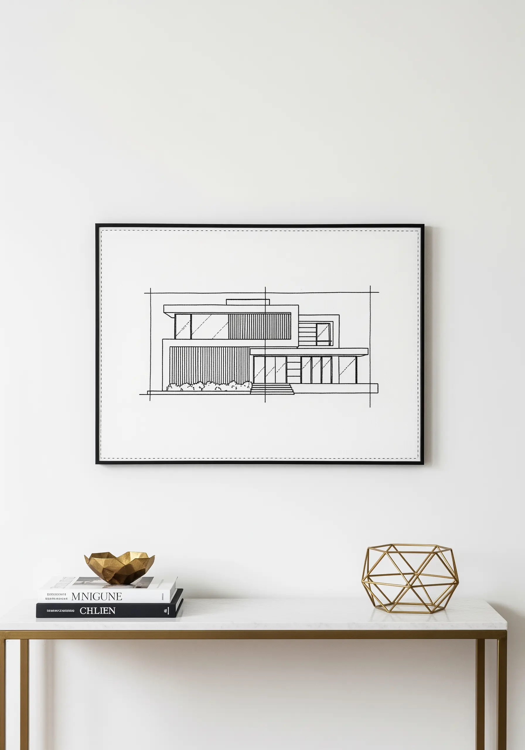 Minimalist black thread embroidery of a modern house on white fabric, framed.