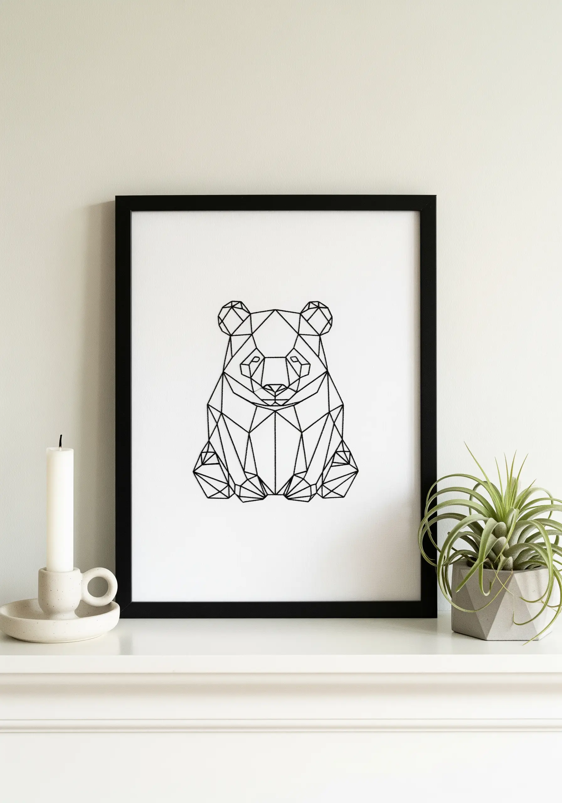 A framed geometric line art drawing of a panda's face.