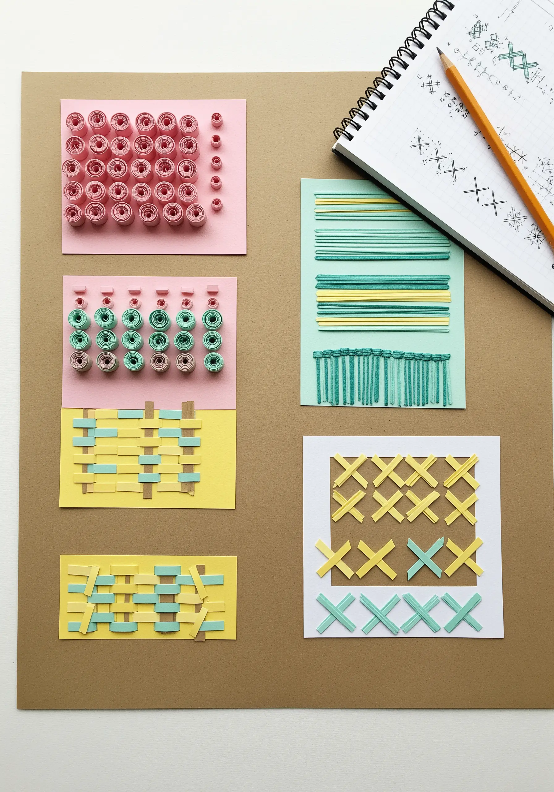 A sampler of paper craft techniques mimicking embroidery, including quilling and weaving.