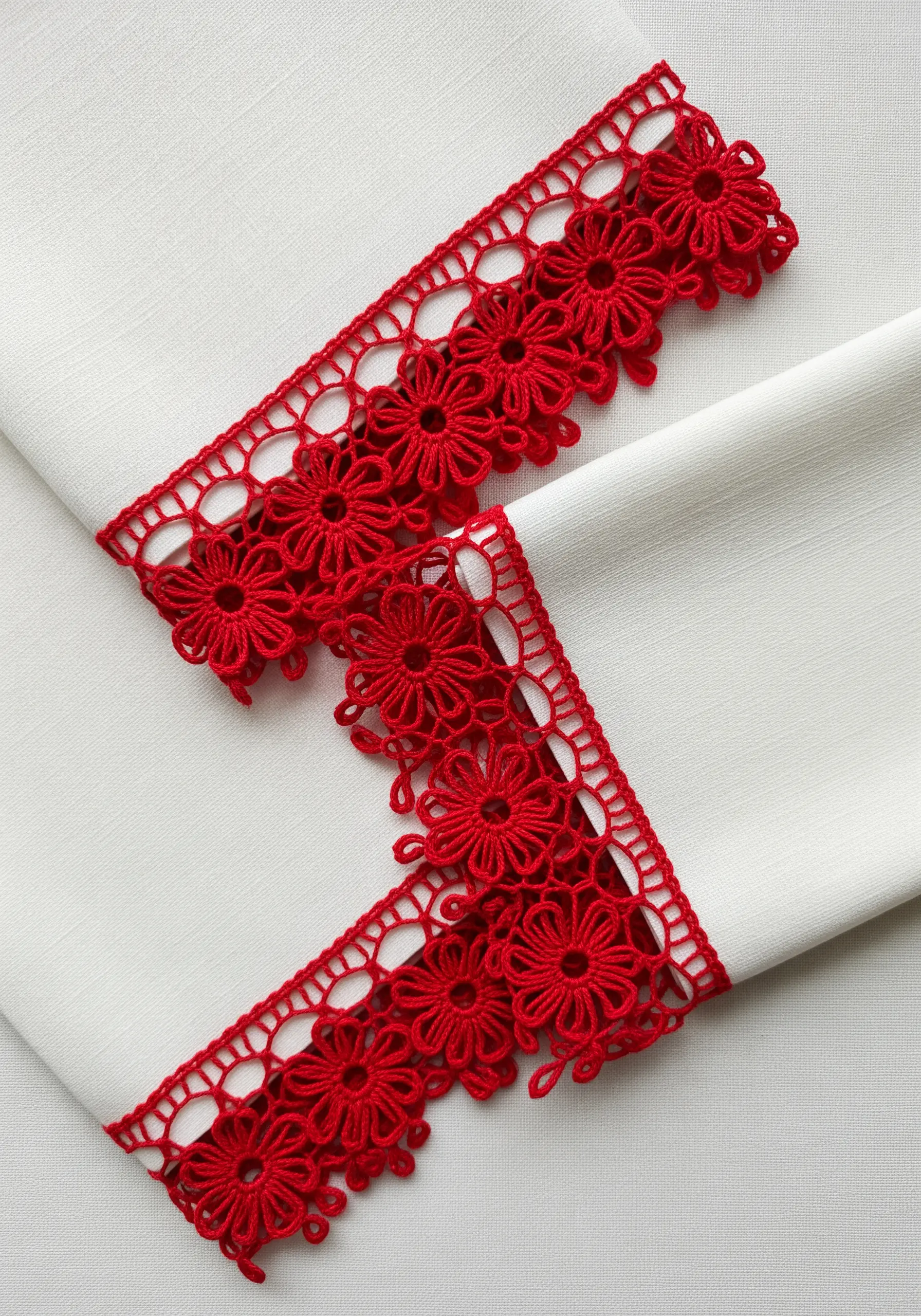 White napkins finished with a vibrant red, floral Turkish Oya needle lace border.