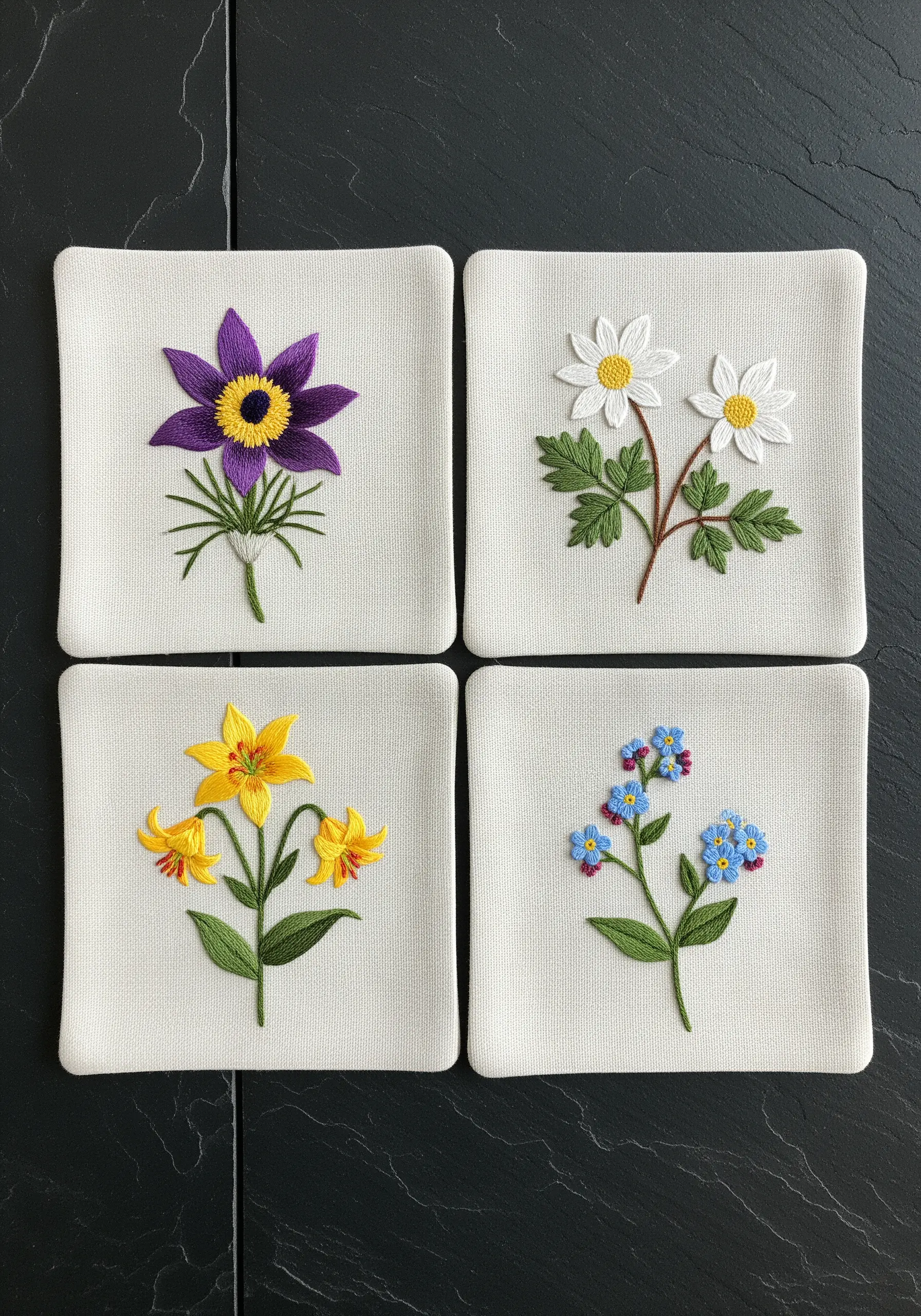 Set of four embroidered coasters, each featuring a different colorful wildflower motif