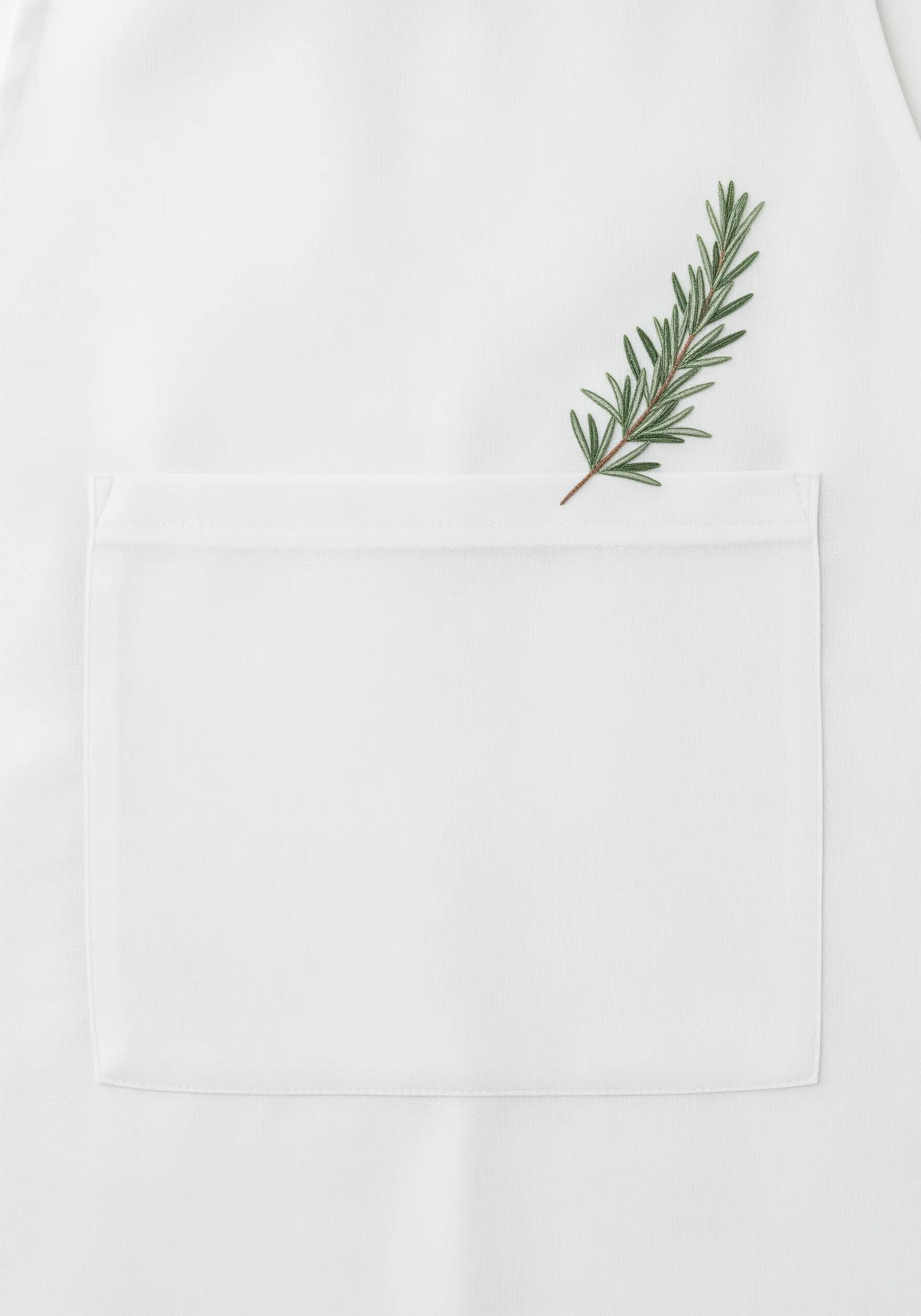 A realistic sprig of rosemary embroidered above the pocket of a white apron.