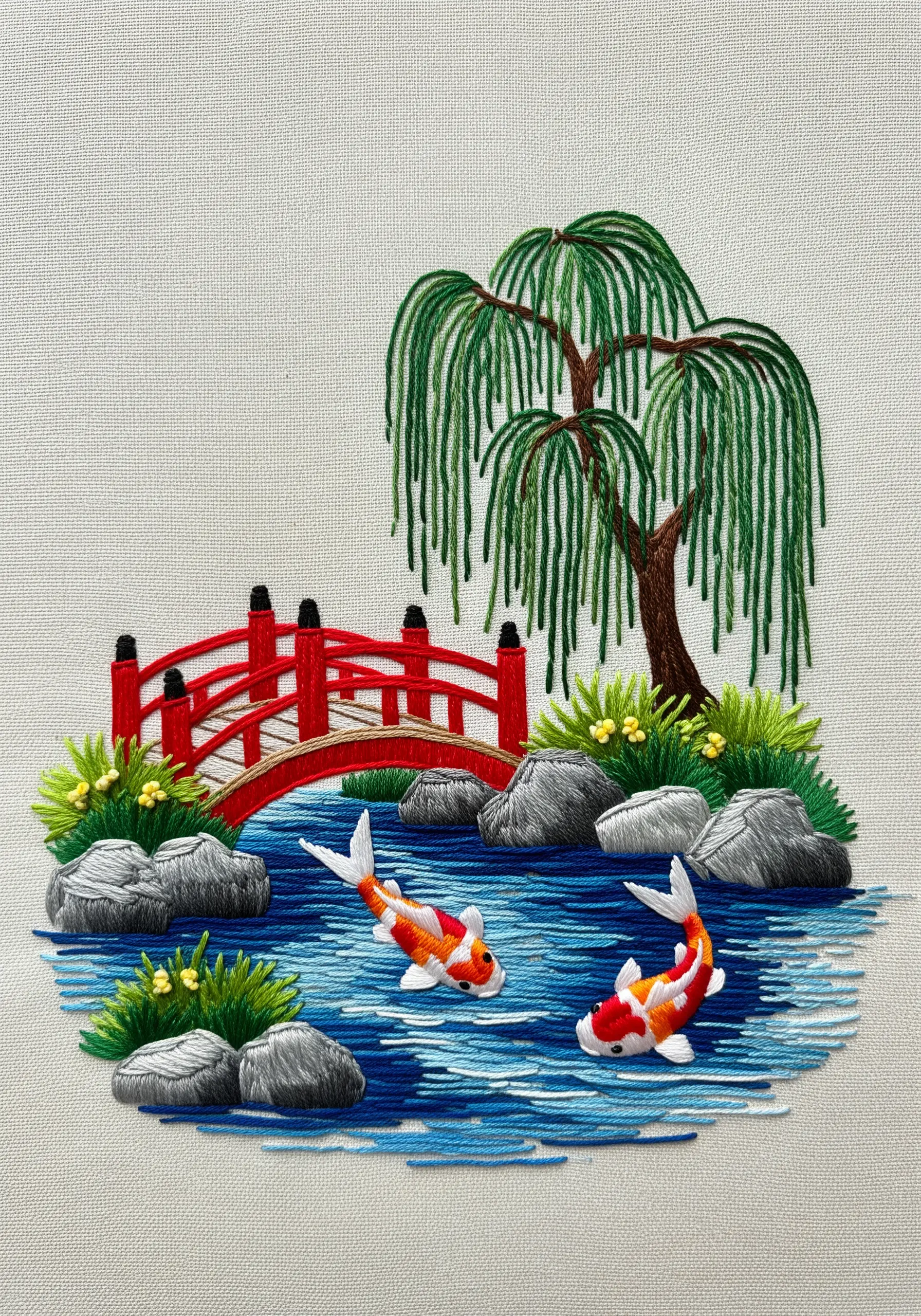 Embroidery of a Japanese garden with a red bridge and two raised koi fish.