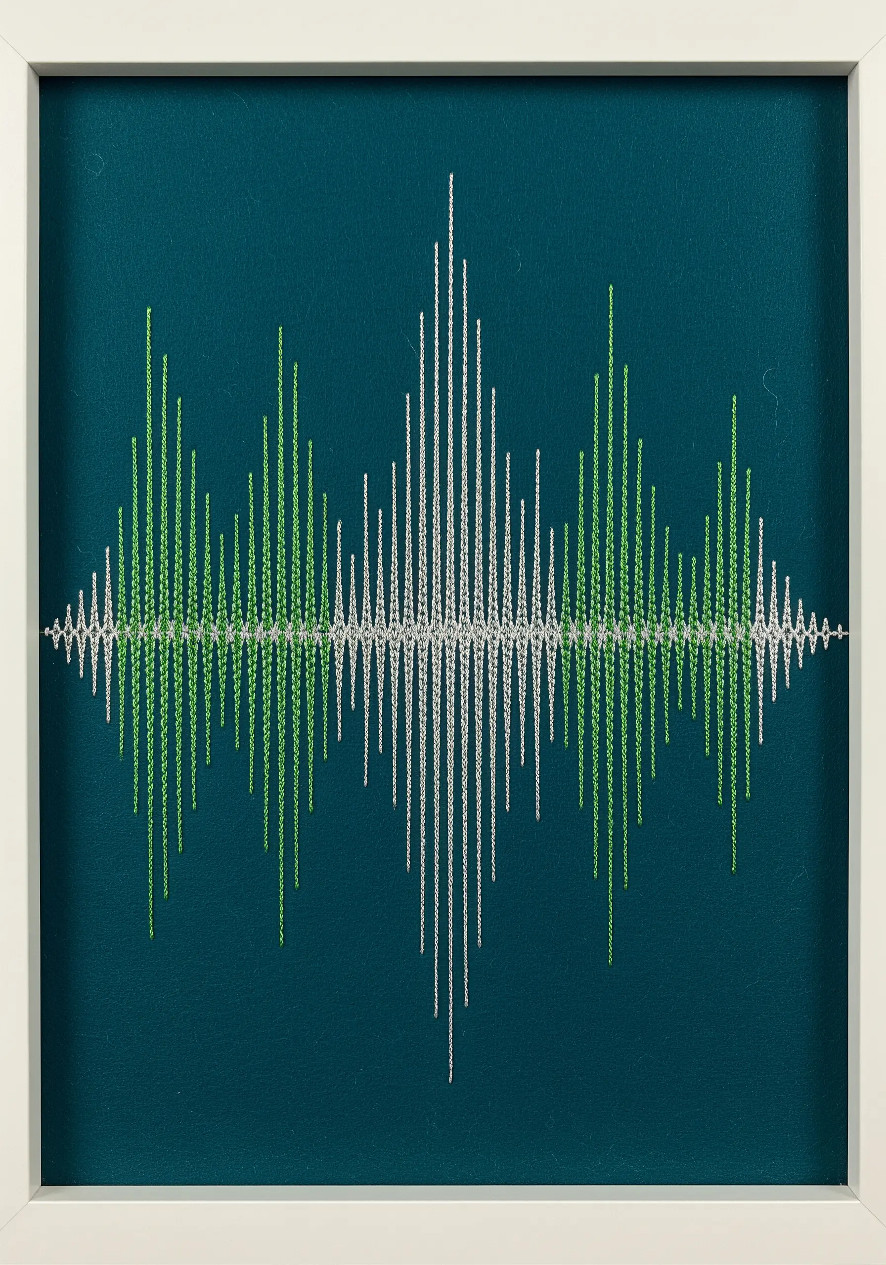 A soundwave embroidered with vertical satin stitches in green and white metallic thread.