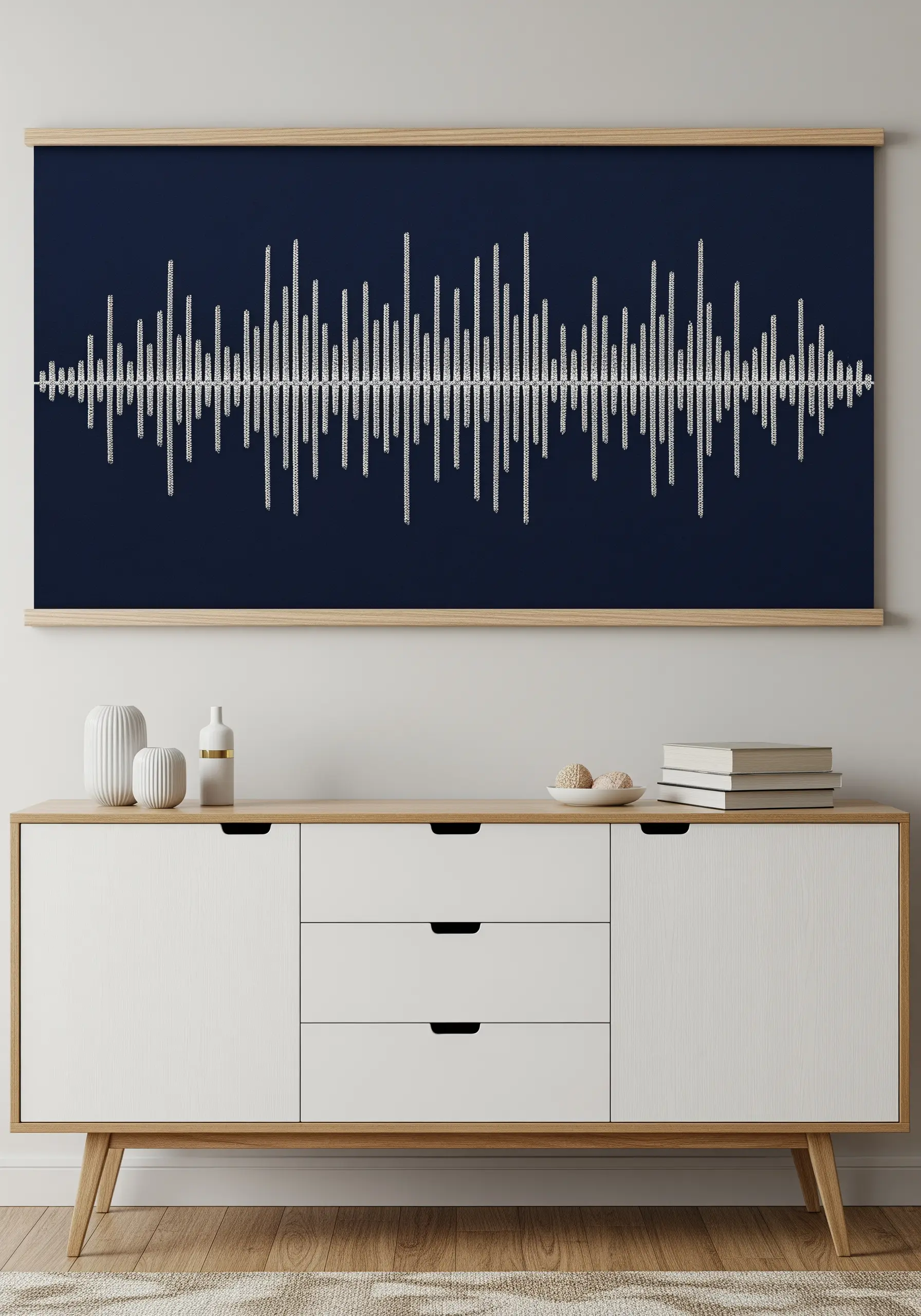 A large framed embroidery of a white soundwave stitched on a navy blue background.
