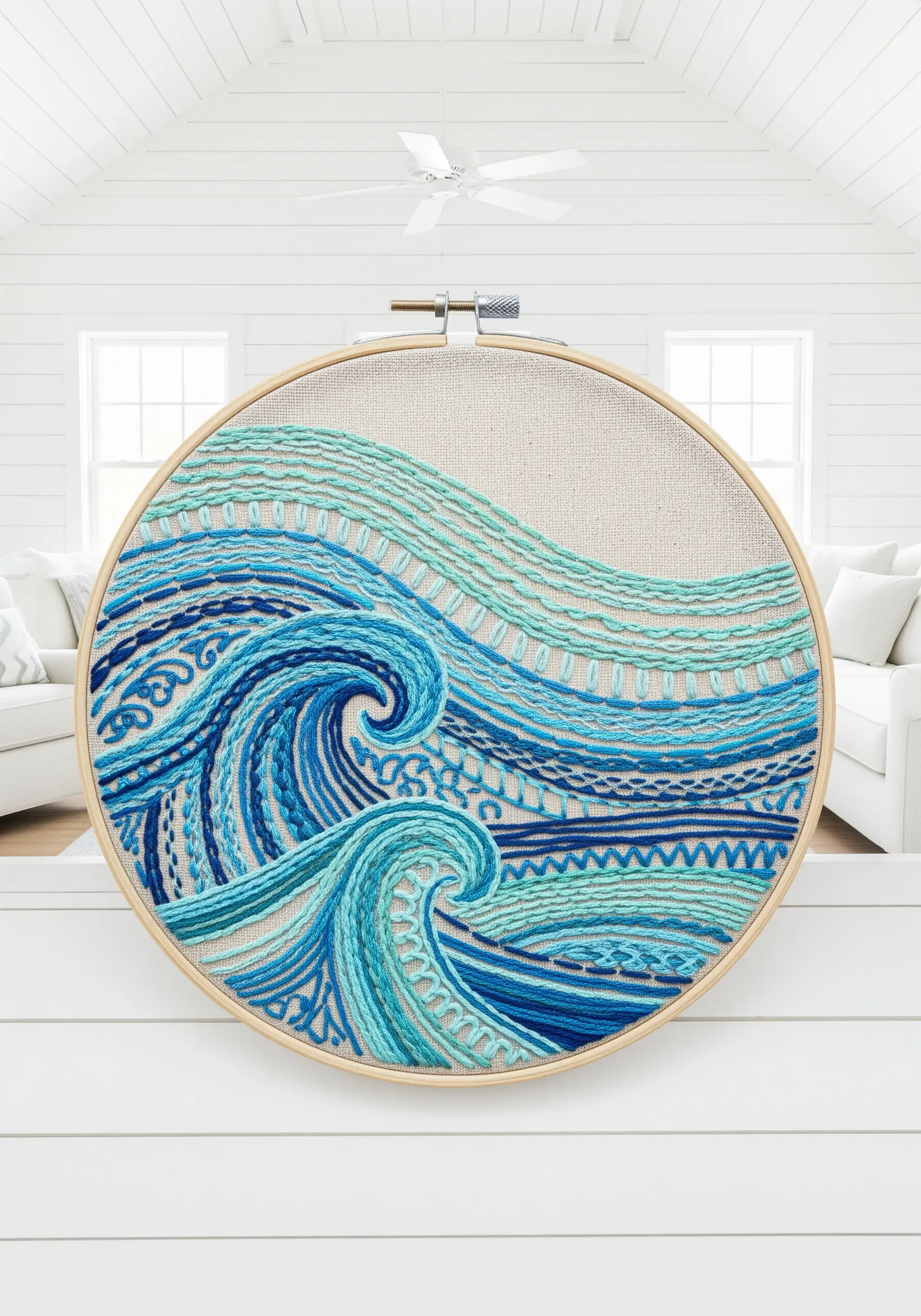 Abstract ocean waves in a large hoop, filled with a variety of blue and teal embroidery stitches.