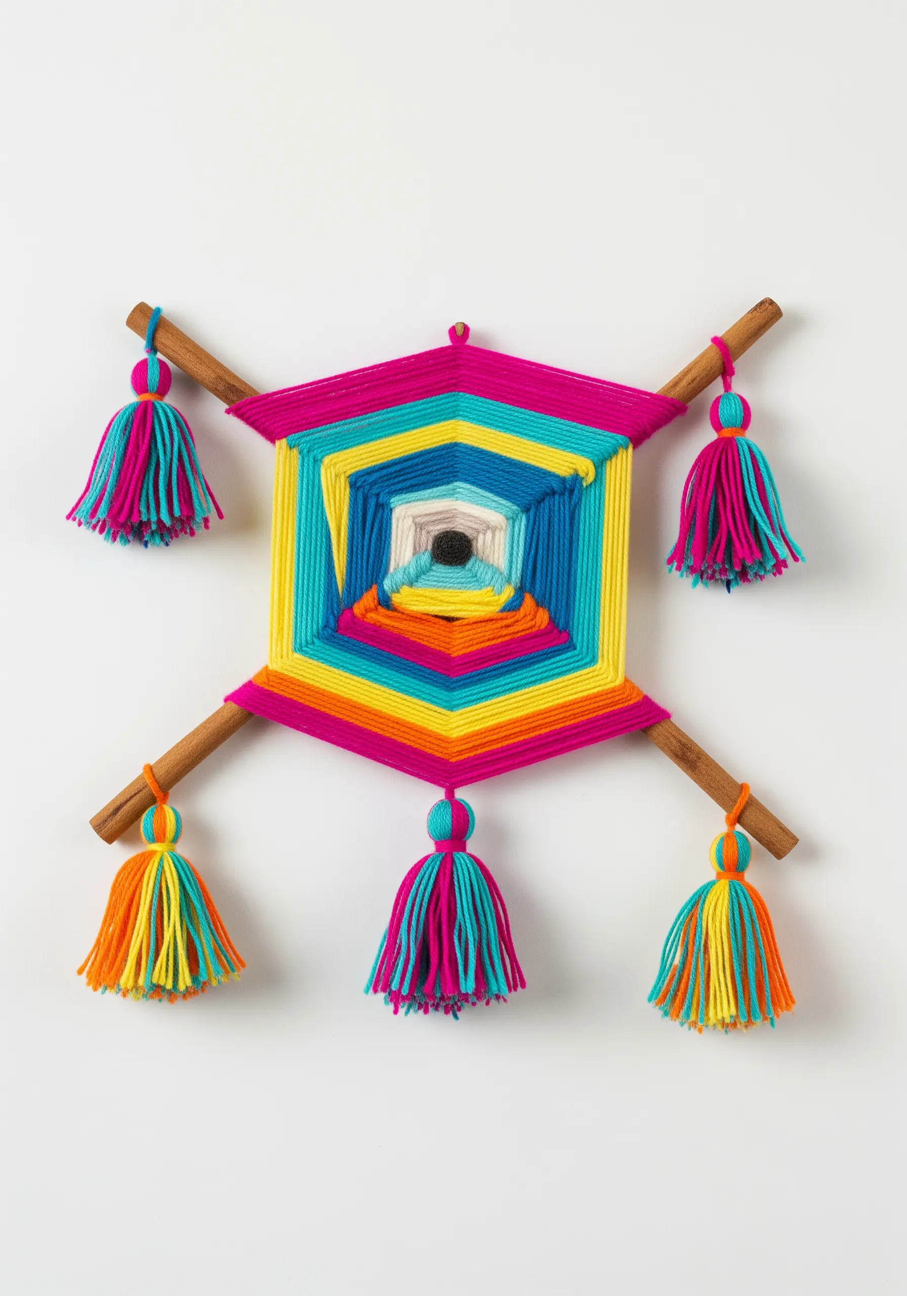 A brightly colored Ojo de Dios yarn weaving with matching tassels on each end.