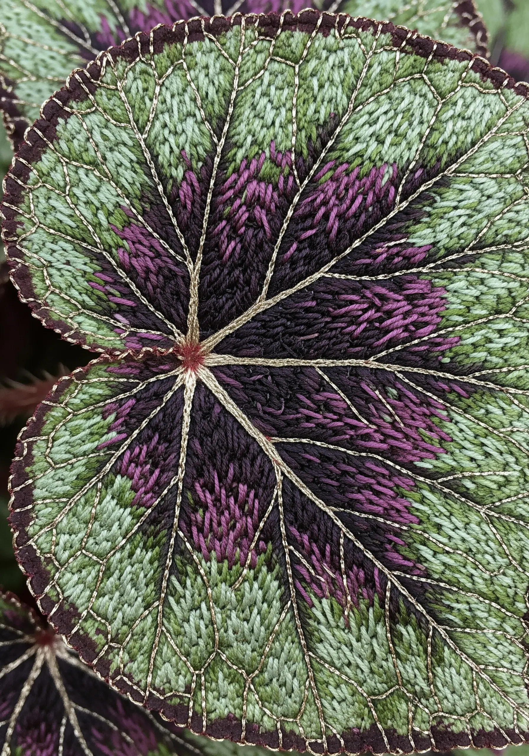 Variegated leaf embroidery with interlocking color blocks and fine metallic veins.