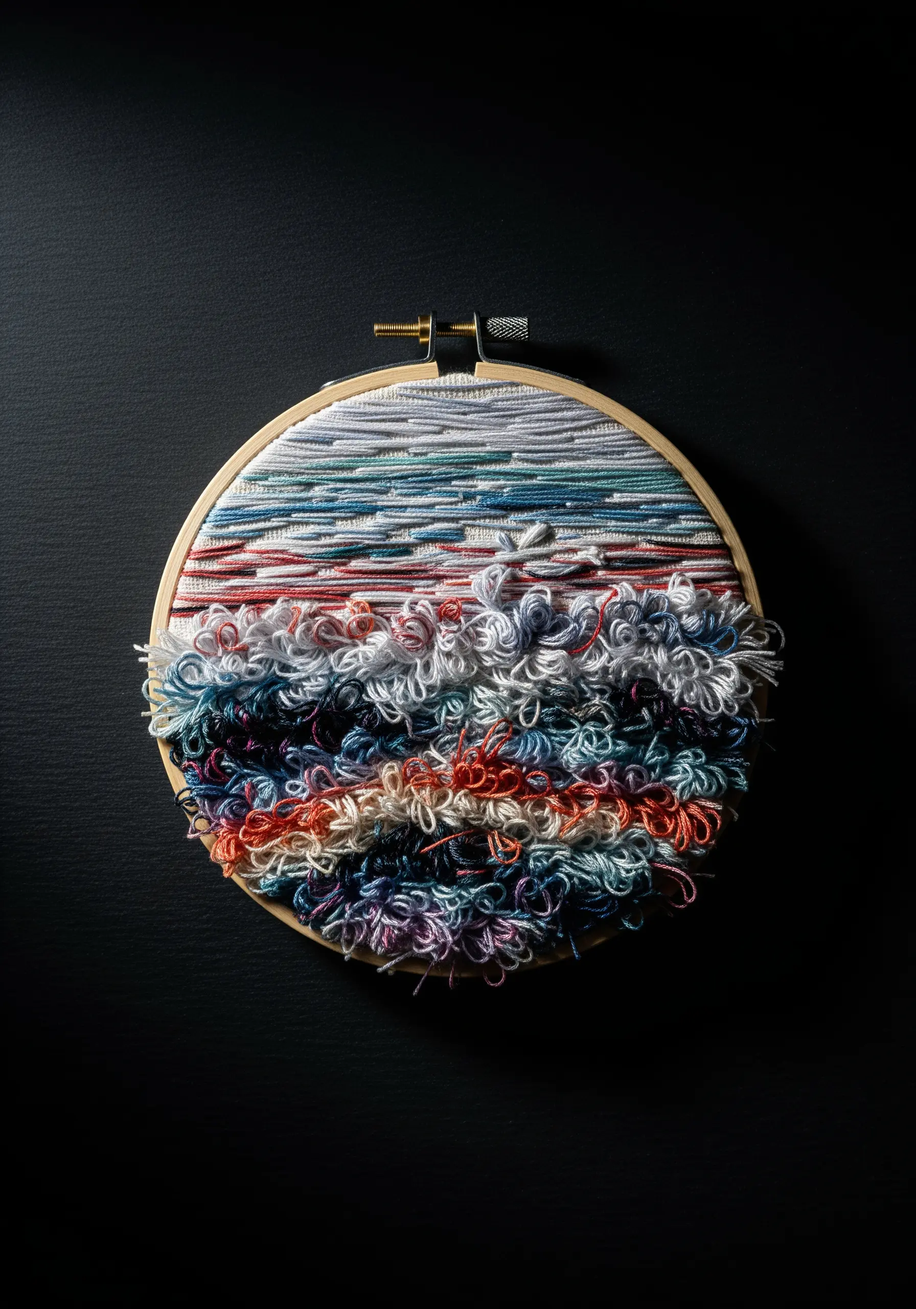 Abstract embroidery hoop art using colorful thread scraps to create a textured seascape.