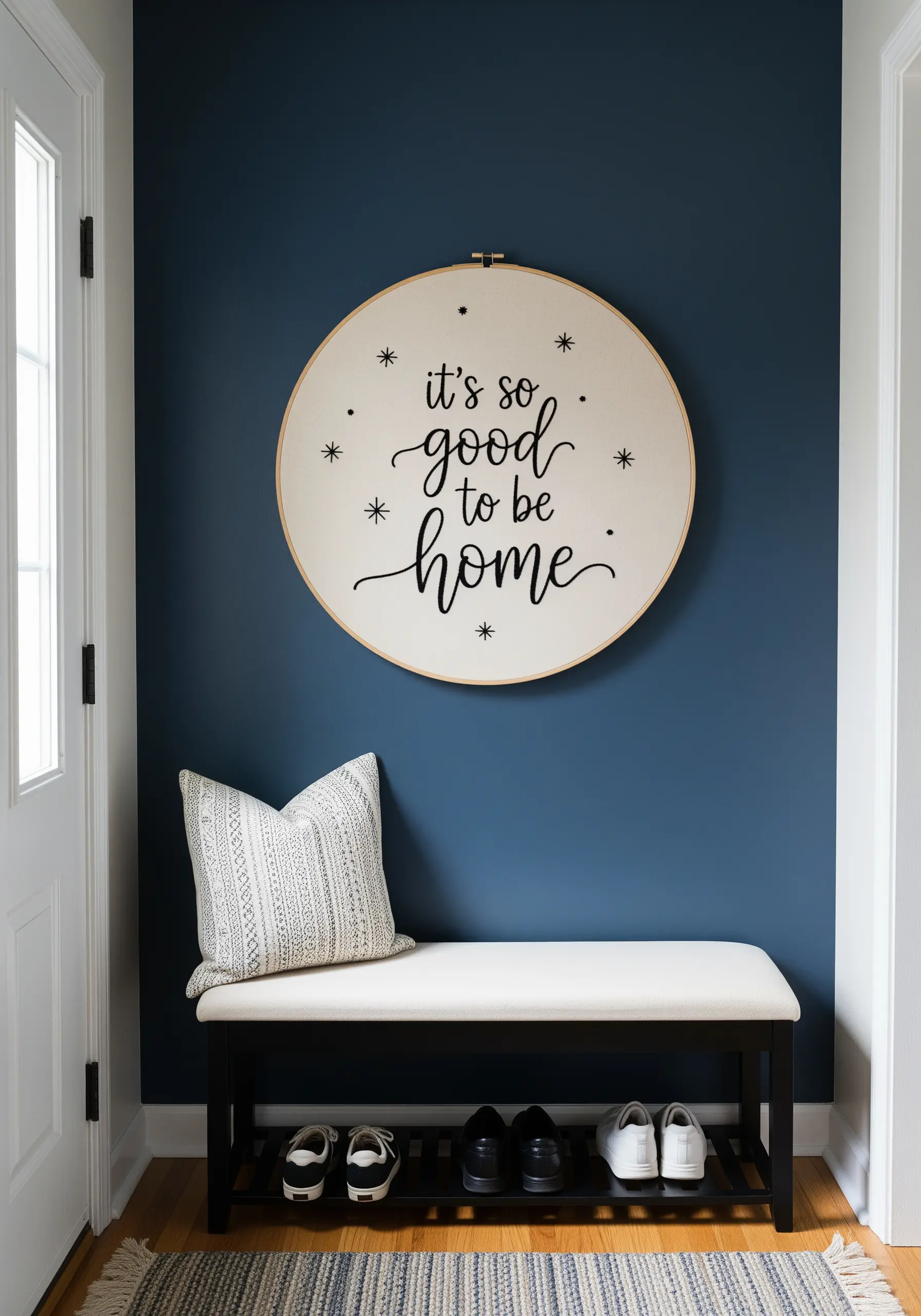 Large hoop with 'it's so good to be home' embroidered in mixed script and print fonts.