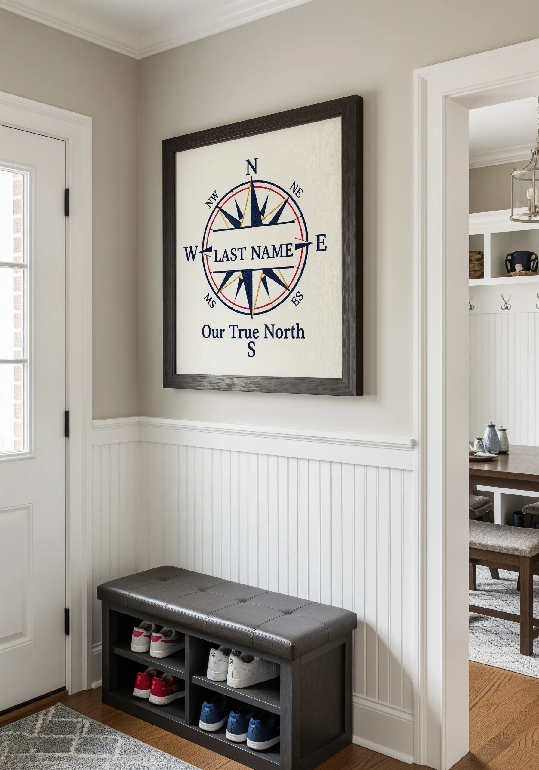 A large, framed embroidery of a compass rose with the family's last name initial at the center.