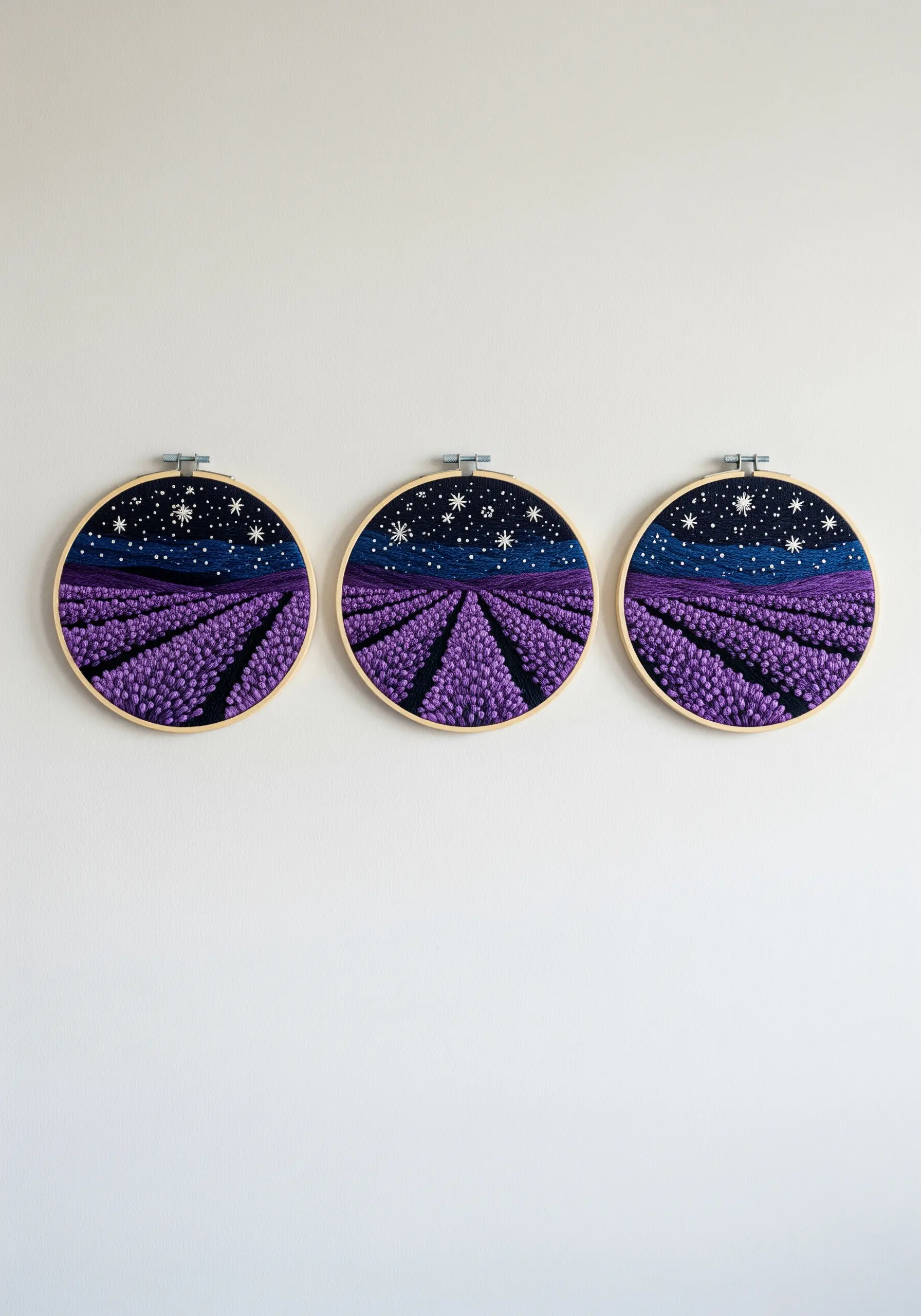 A triptych of embroidery hoops showing a lavender field under a starry night sky.
