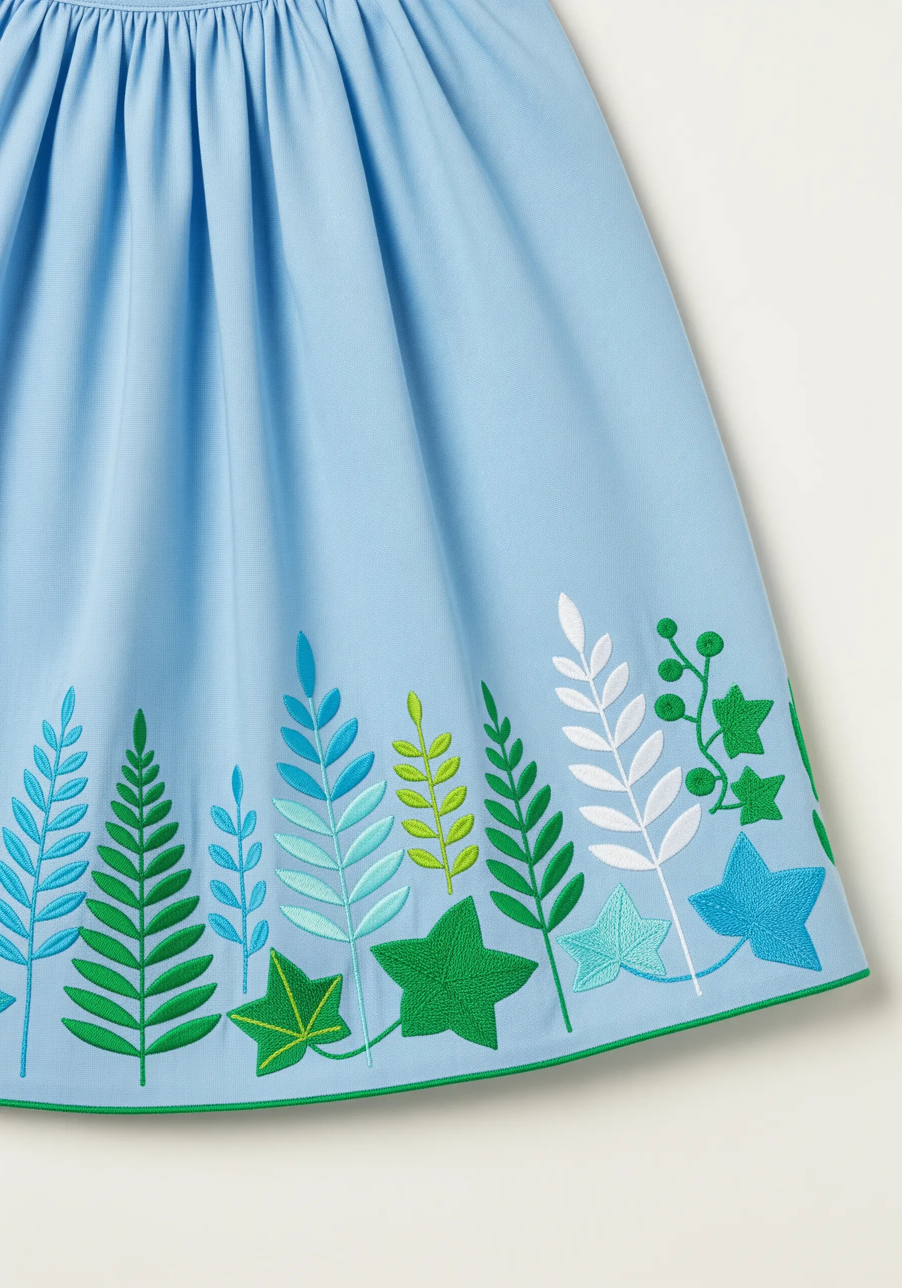 A colorful border of stylized ferns and ivy leaves in blues, greens, and white on a blue skirt.