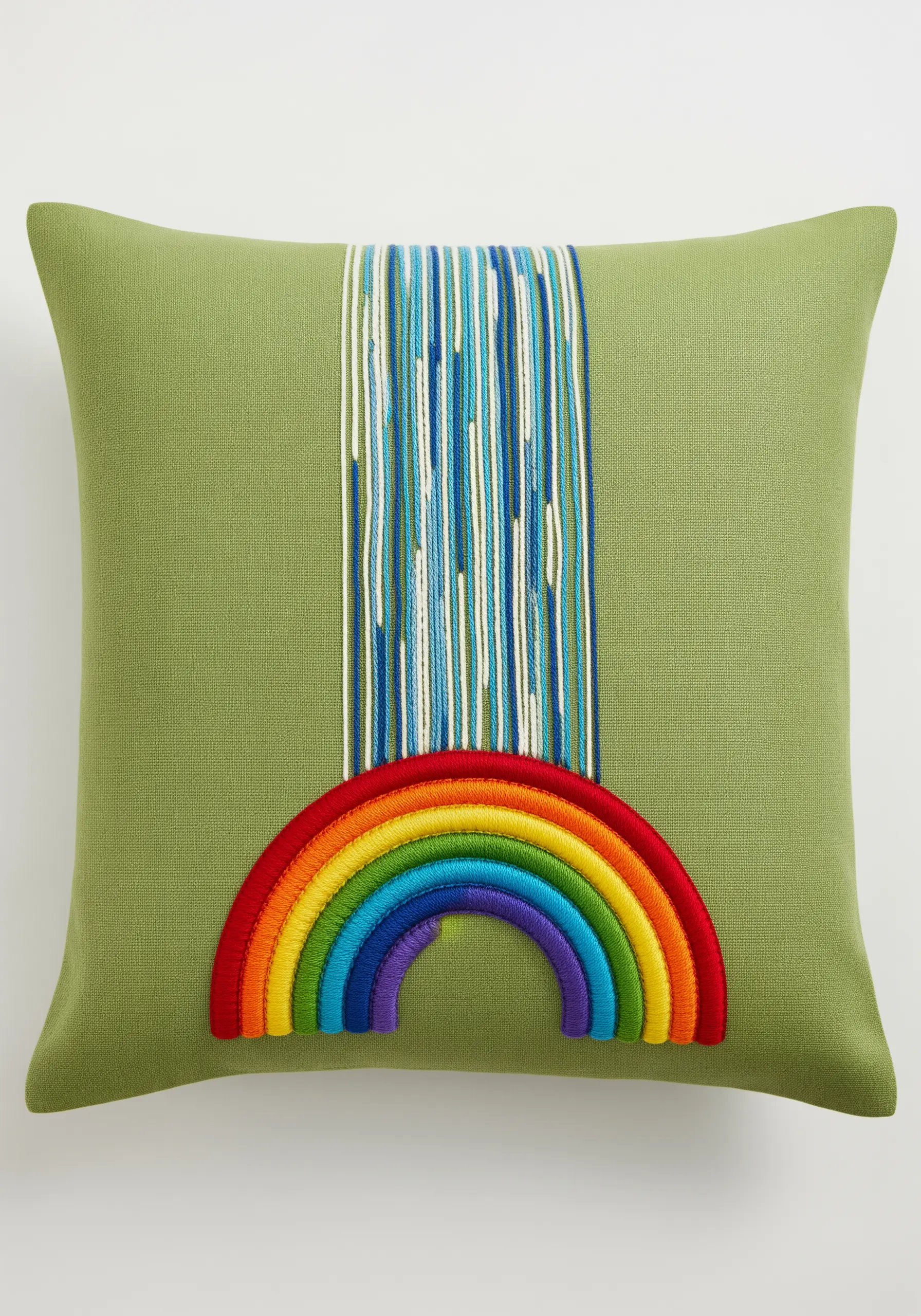 A modern embroidered design with a satin-stitched rainbow and a waterfall of loose threads.