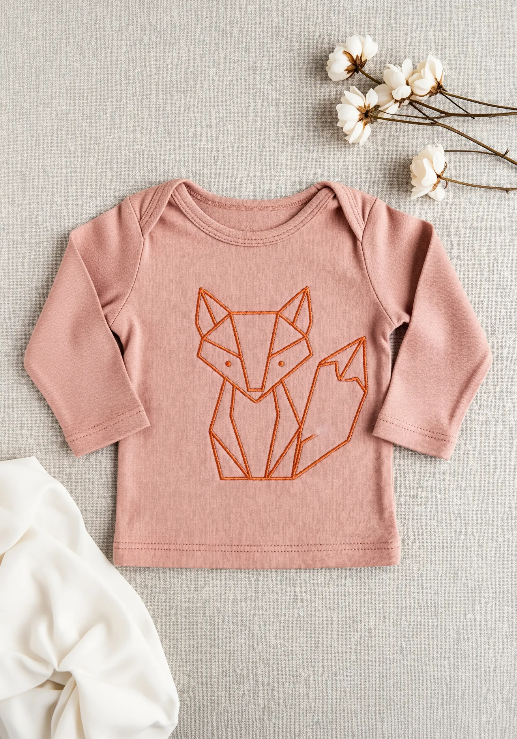 Geometric fox outline embroidered in a bold, rust-colored whipped backstitch.