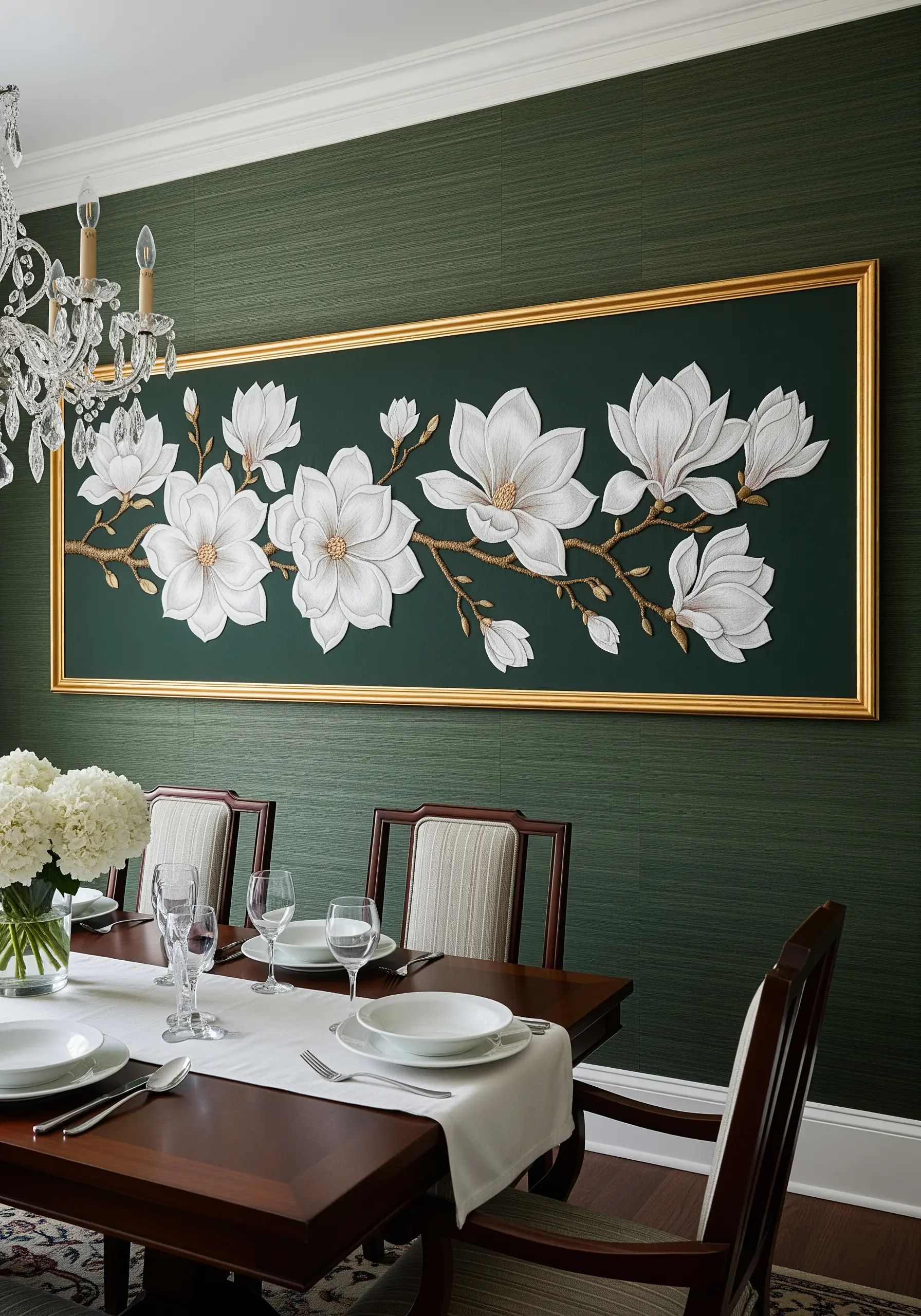 A long, framed embroidery of white magnolias on a branch against a dark green wall.