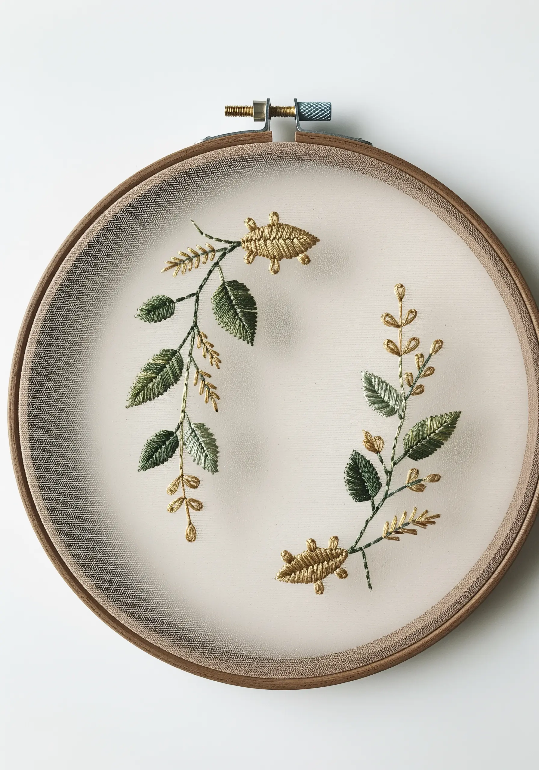 Delicate green and gold botanical branches embroidered on sheer tulle, making them appear to float.