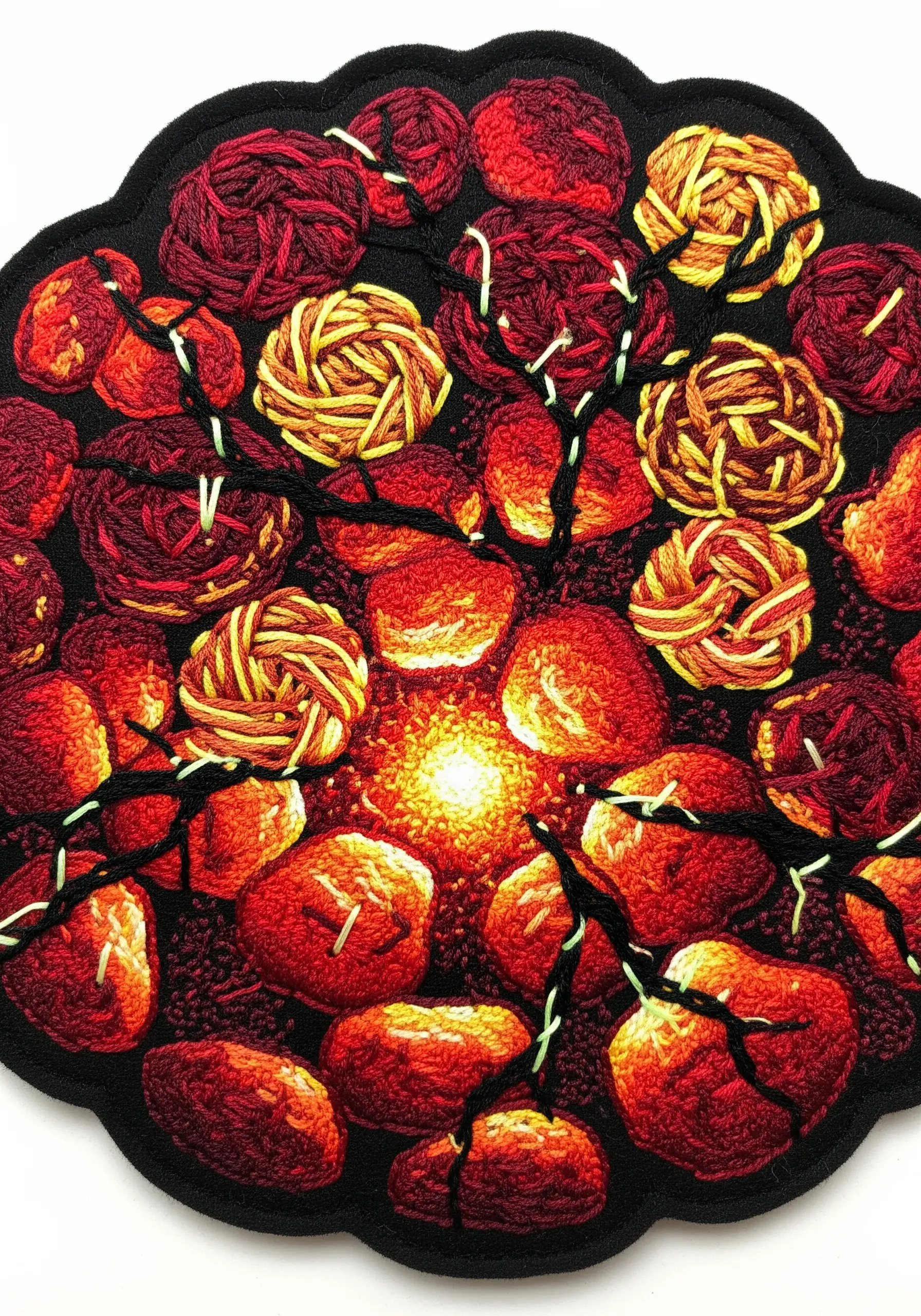 Highly detailed embroidered embers glowing with a thread-painted effect.