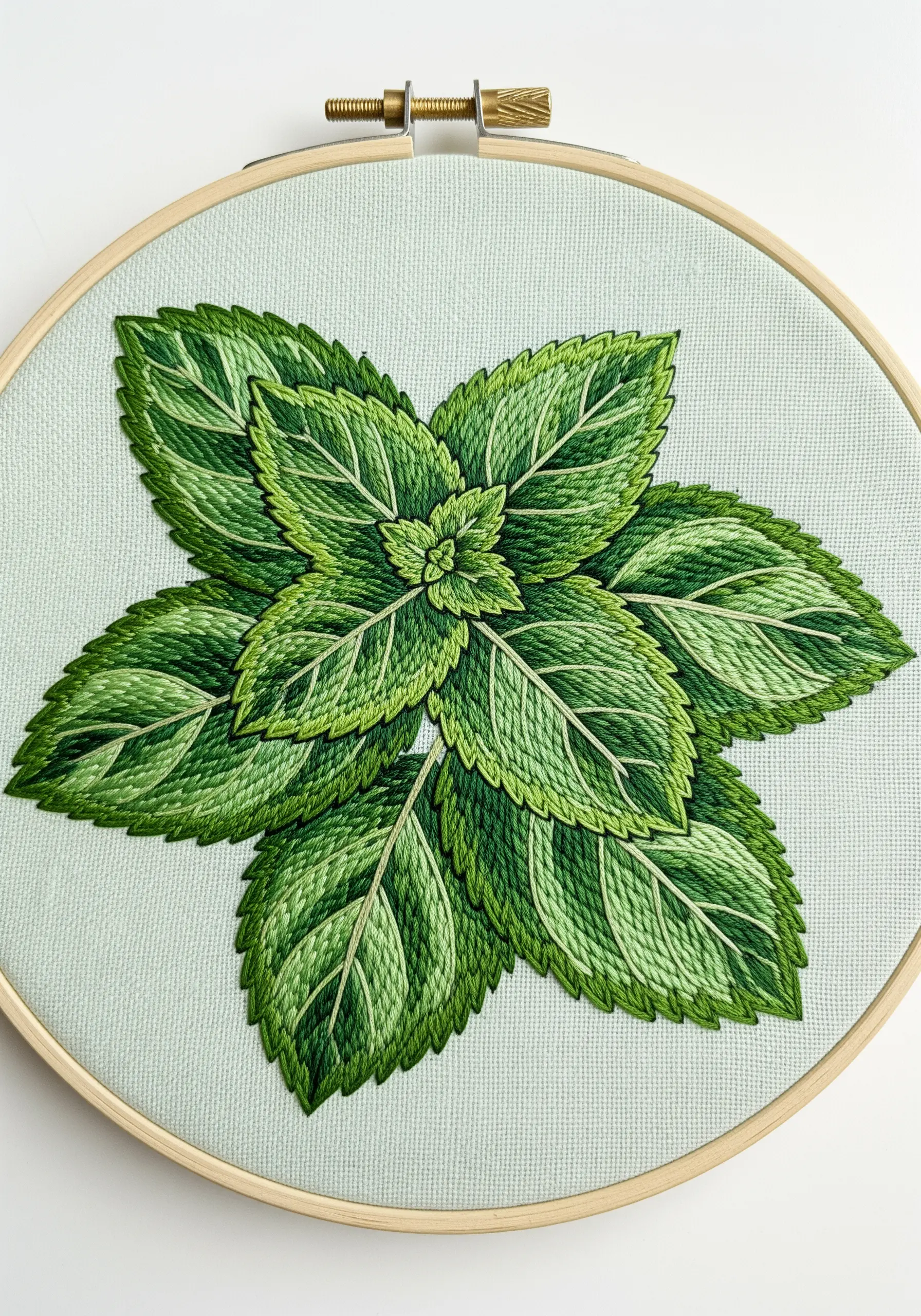 Intricate thread-painted mint leaves showing detailed veins and color gradients.