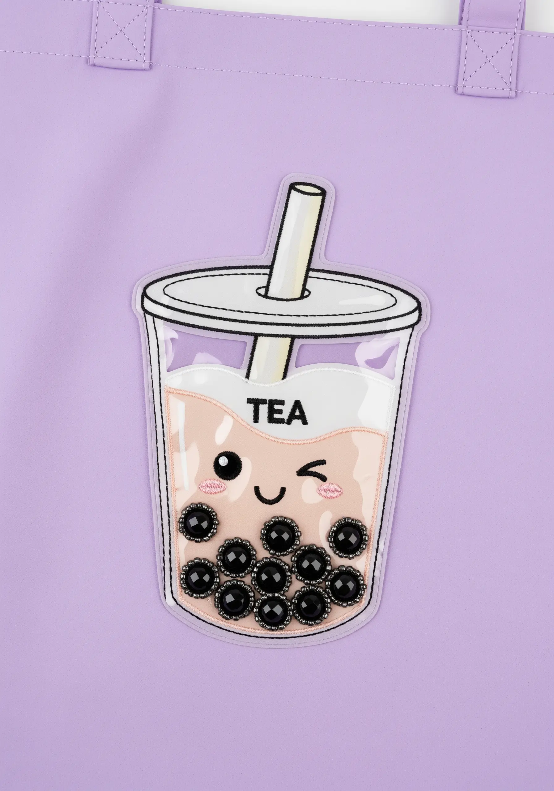 A kawaii boba tea design using black beads for tapioca pearls on a purple tote bag.