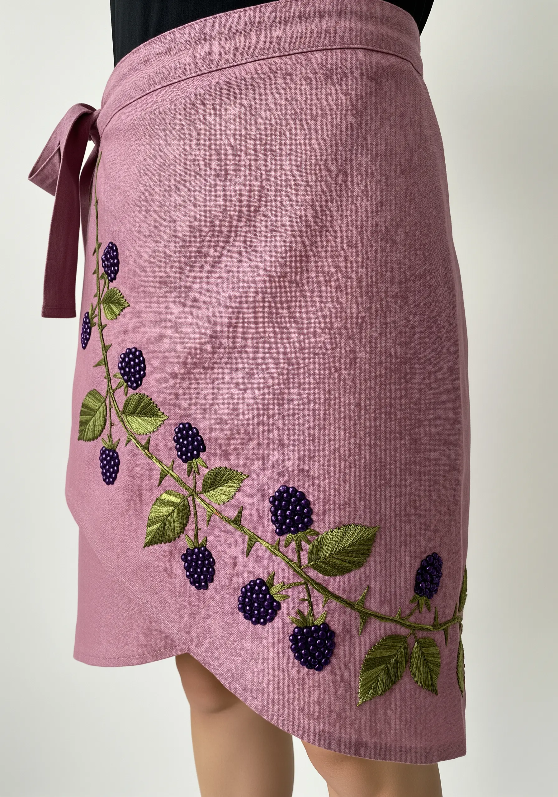 A climbing blackberry vine embroidered on a mauve skirt with purple beads for berries.