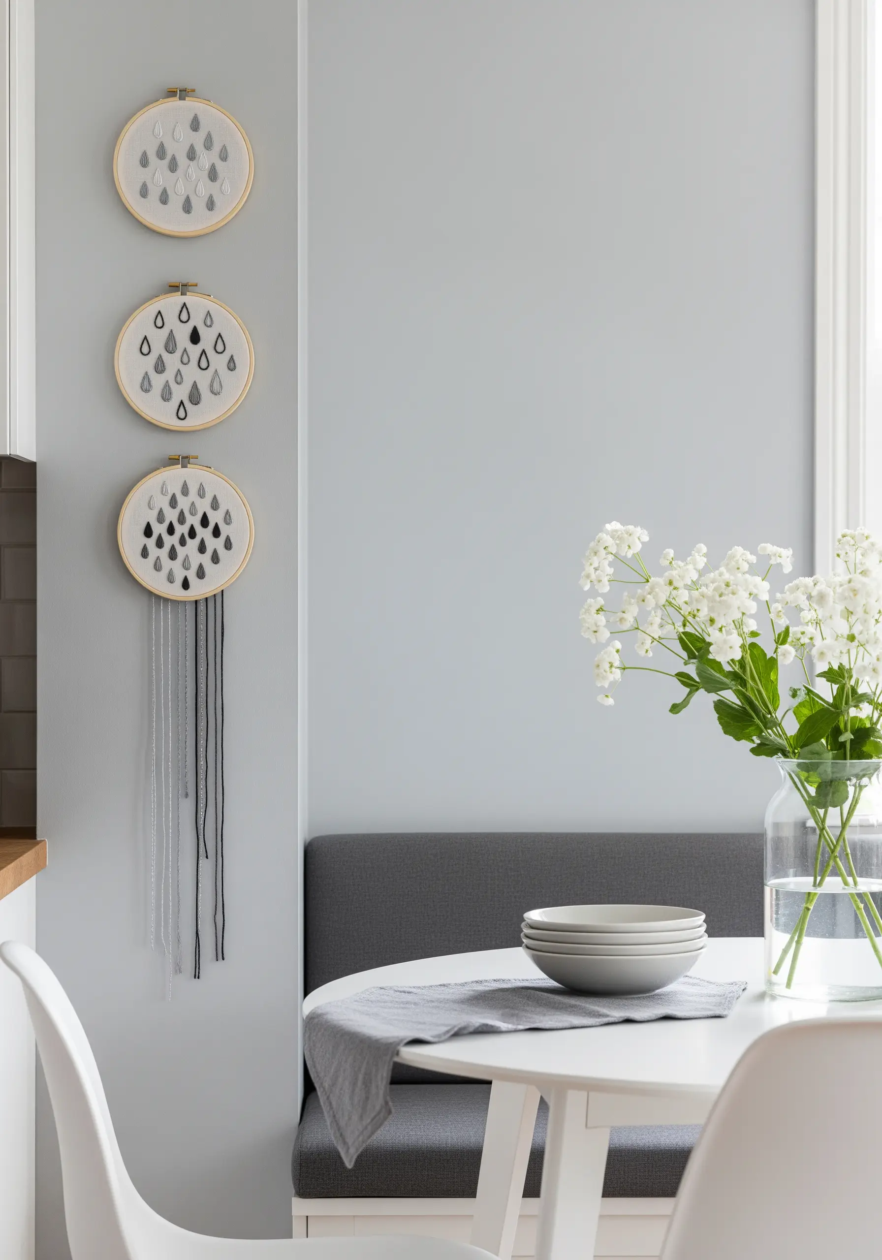 Three hoops with embroidered raindrops, with long threads hanging down like rain.