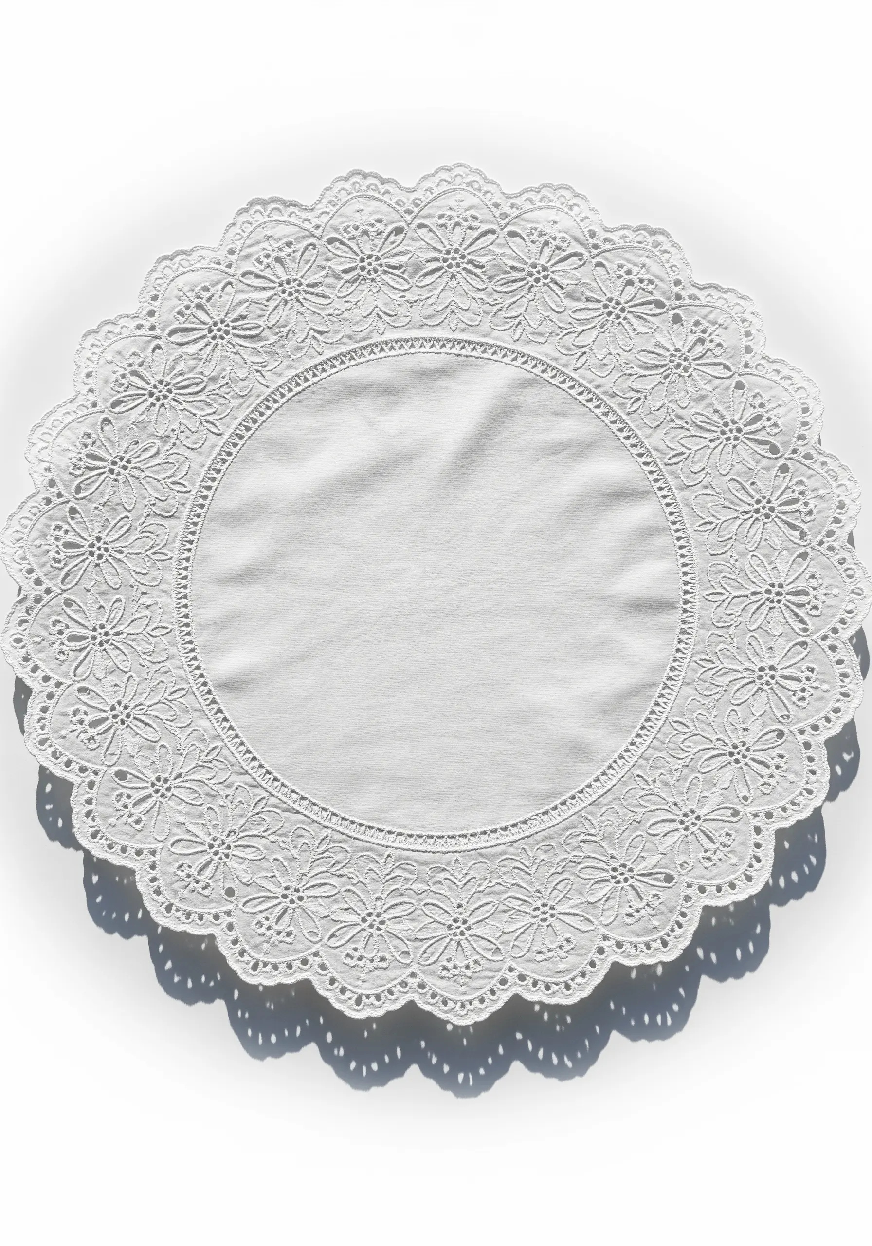 A highly intricate circular white doily featuring advanced cutwork and needle lace fillings.