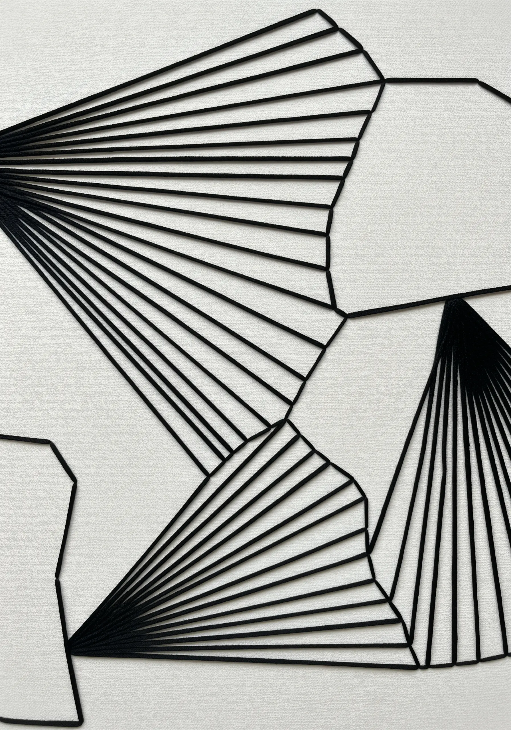 Minimalist black thread creating abstract geometric shapes on a white background.