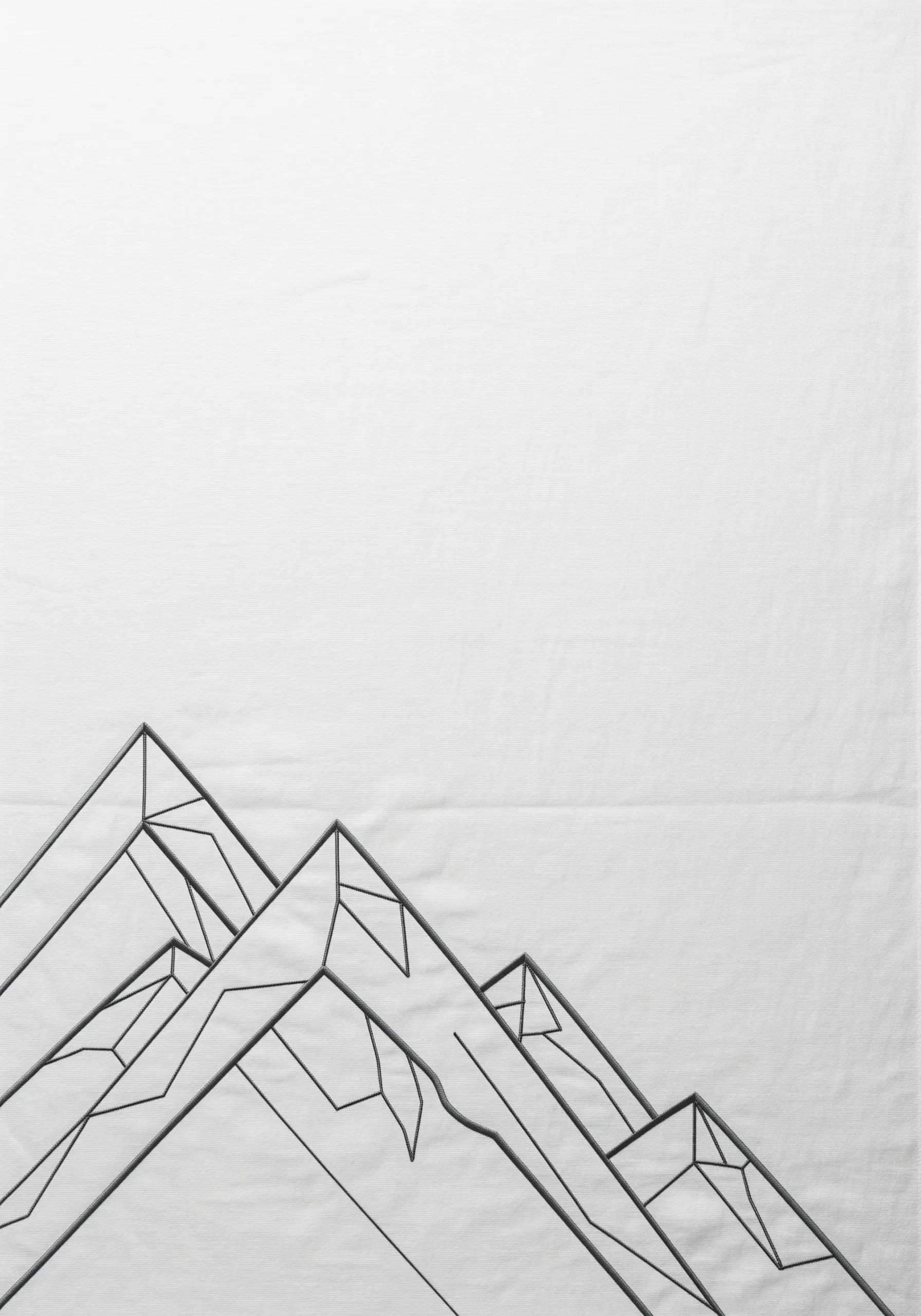 Geometric mountain range embroidered in clean black lines on white fabric.