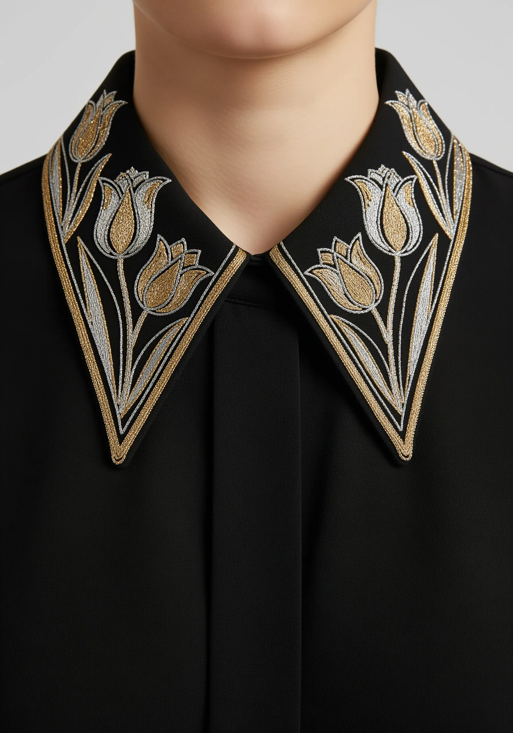Art Deco style tulips in gold and silver metallic thread on a black shirt collar.