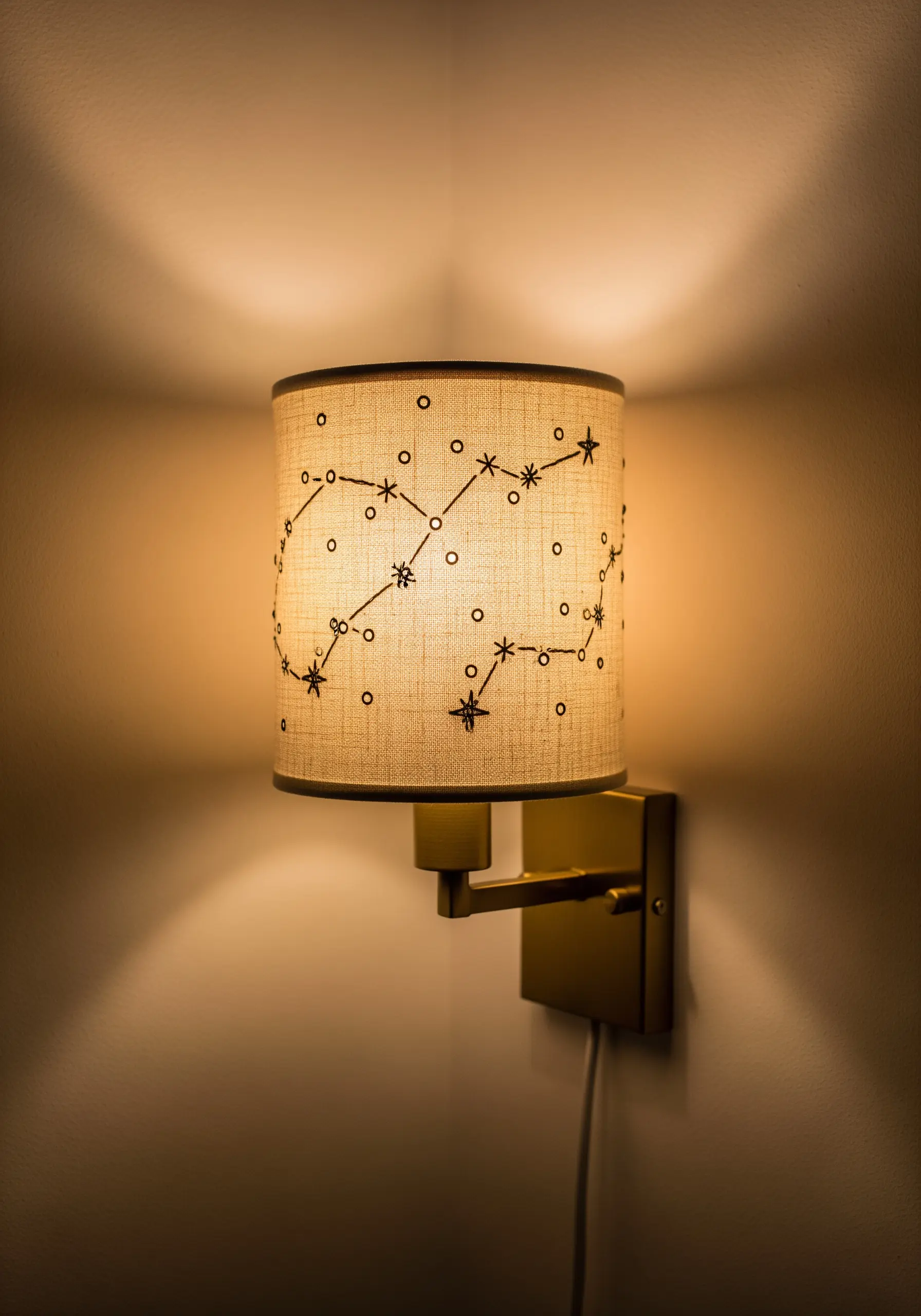 Lampshade with black stitched constellation patterns and light holes