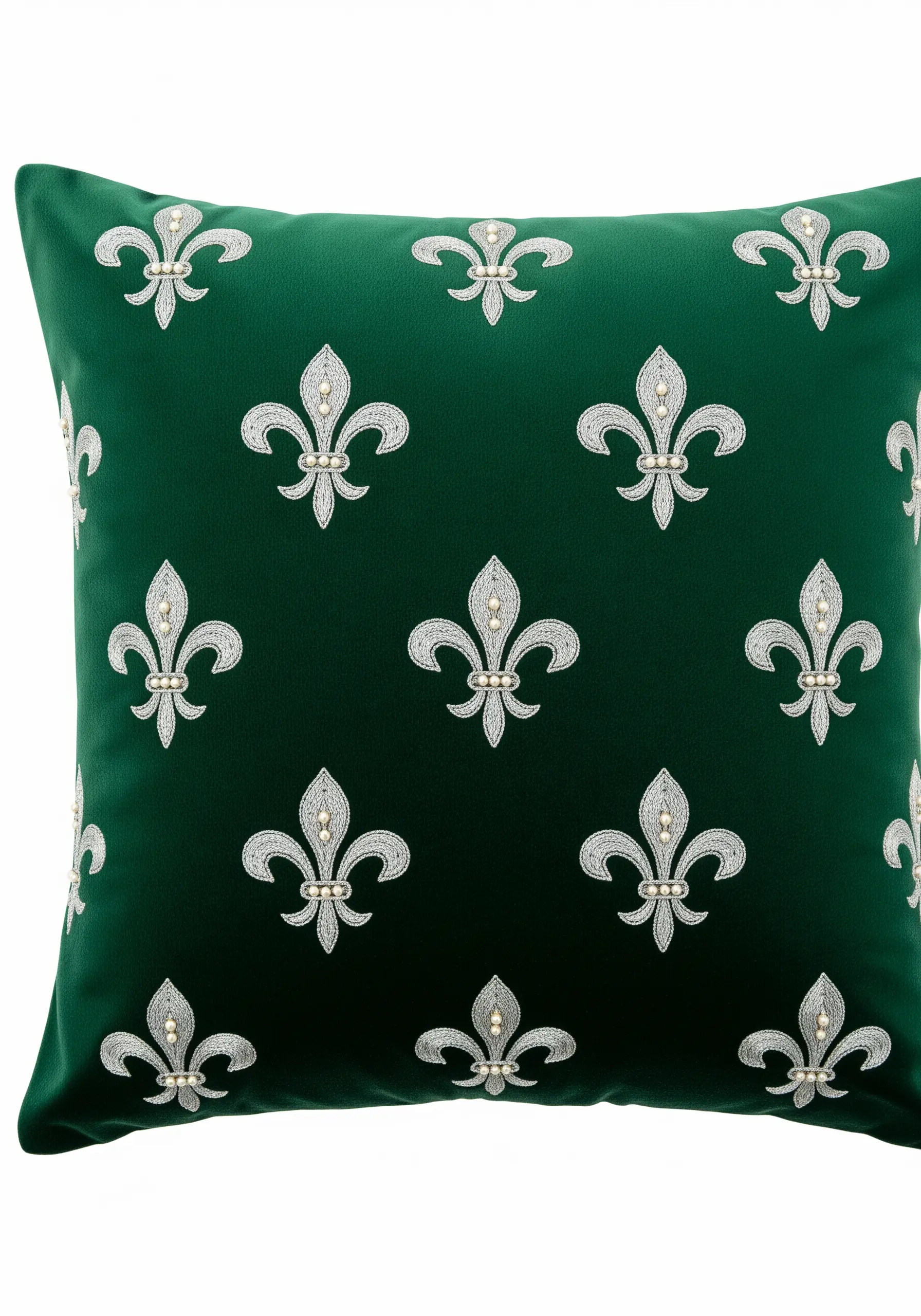 A pattern of silver and pearl beaded fleur-de-lis on a green velvet cushion.