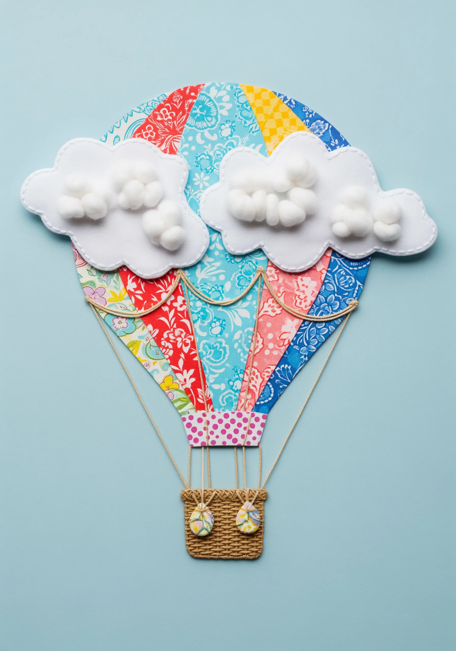 A hot air balloon made from patterned fabric appliqué, outlined with simple stitching.