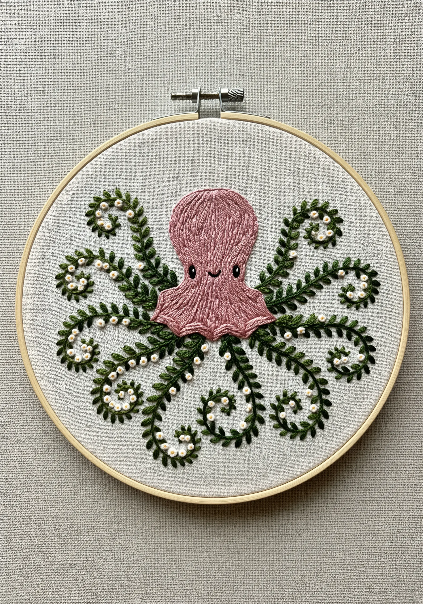 A pink octopus with green, leafy tentacles dotted with small white pearl beads.