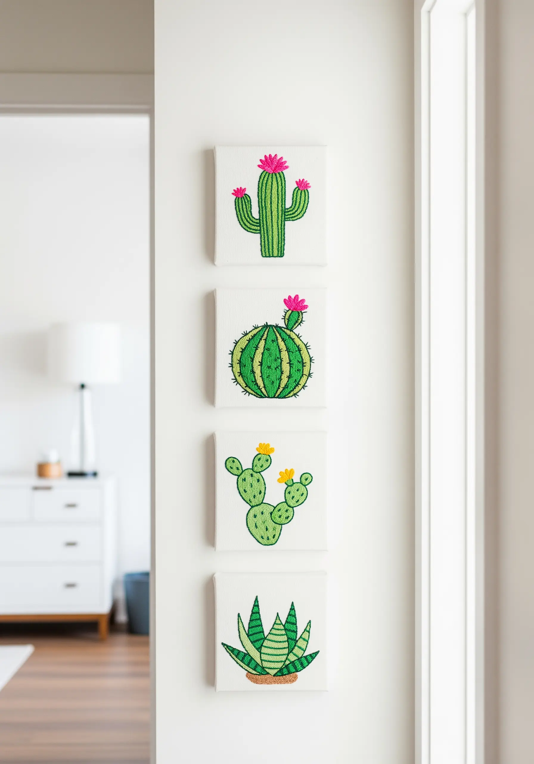 A set of four small canvases, each embroidered with a different type of cactus.