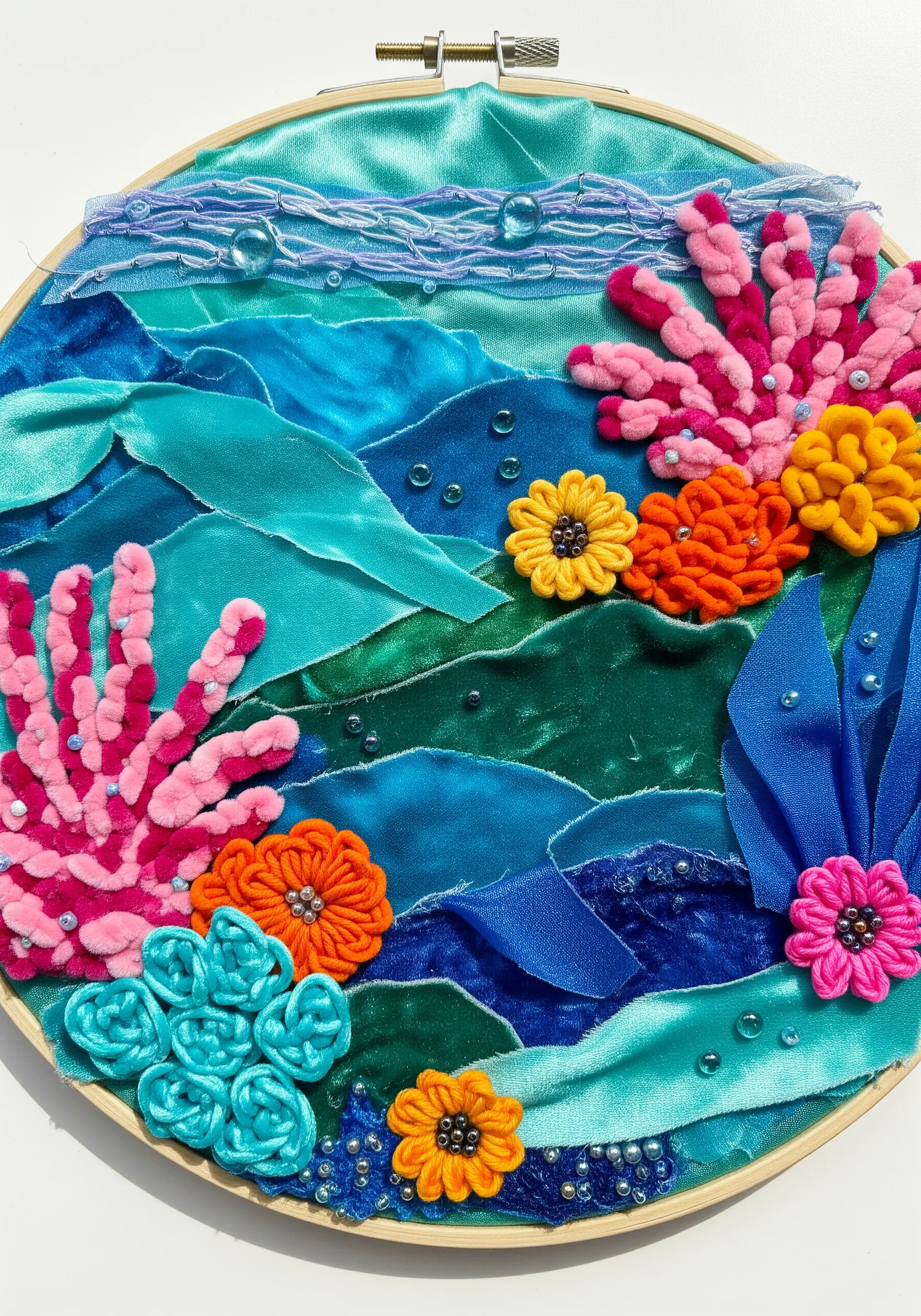 Vibrant underwater coral reef embroidery using velvet, satin, and beaded details.